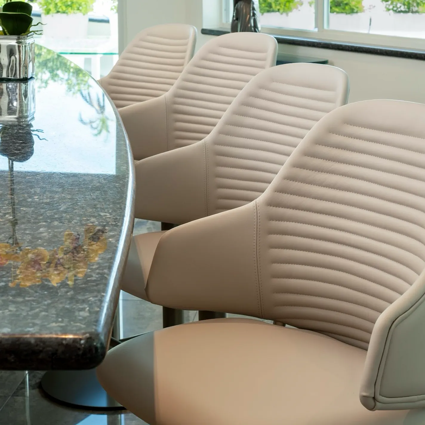 a row of chairs next to a table