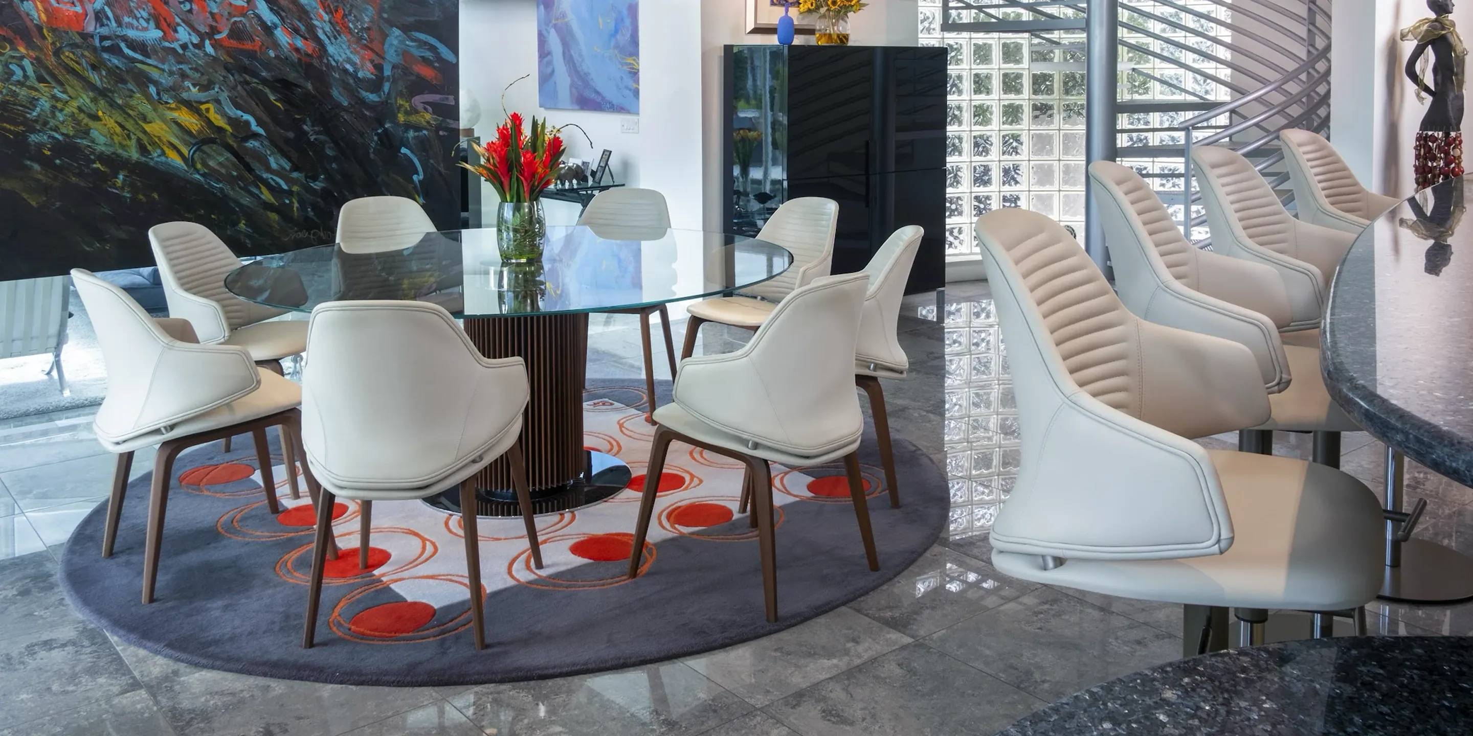 a room with a glass table and chairs