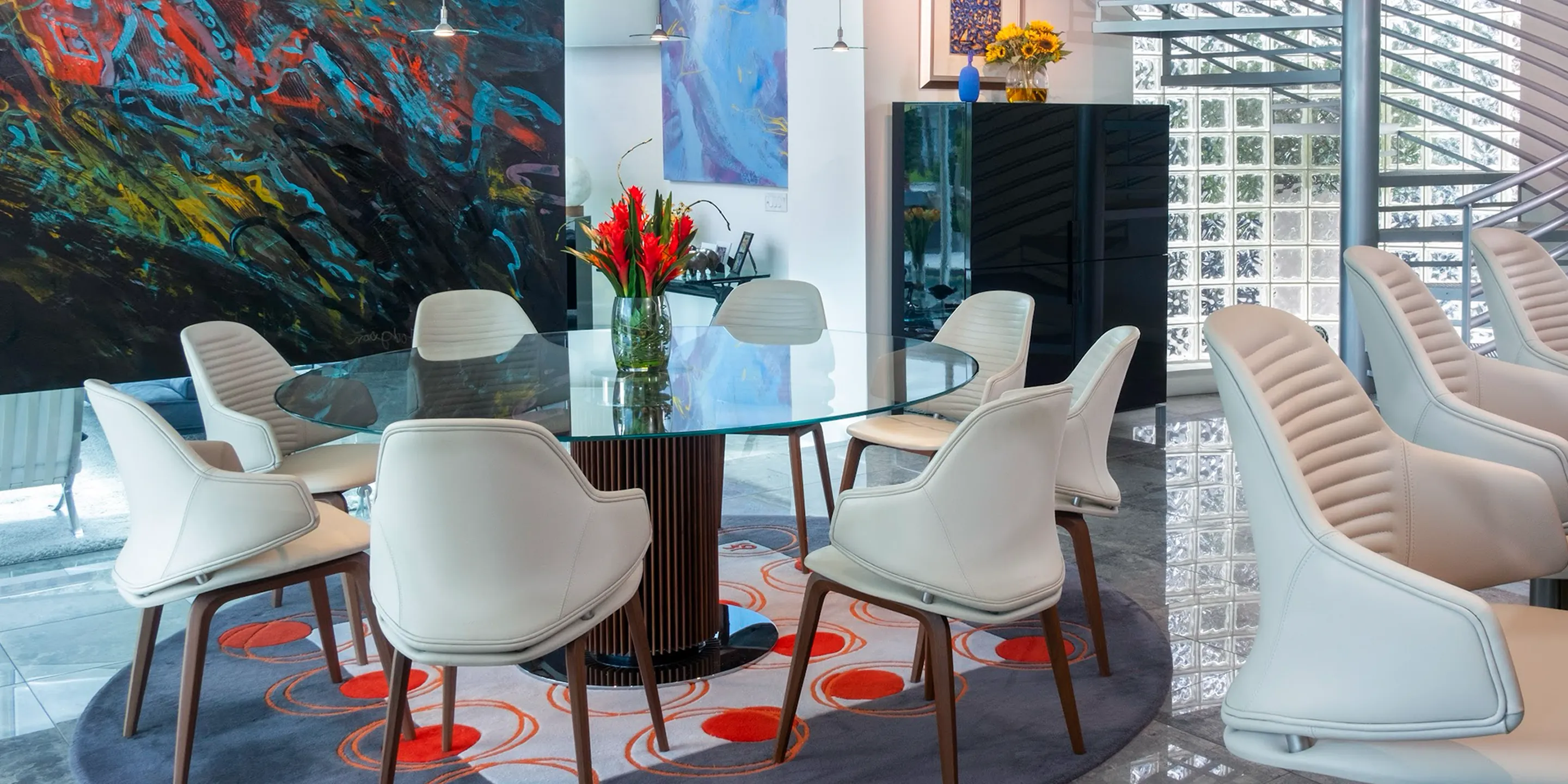 a room with a glass table and chairs