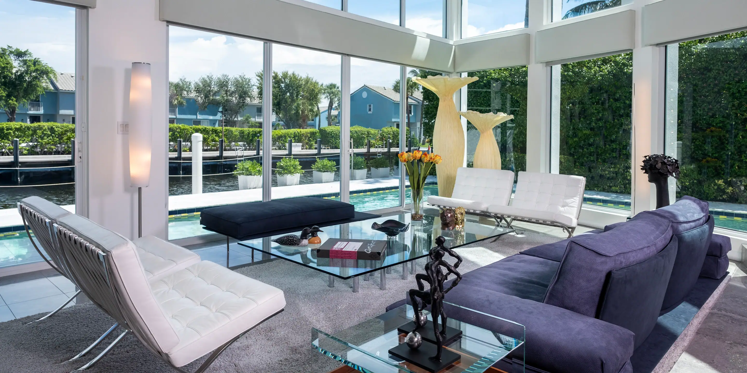 A living room with large windows and furniture.