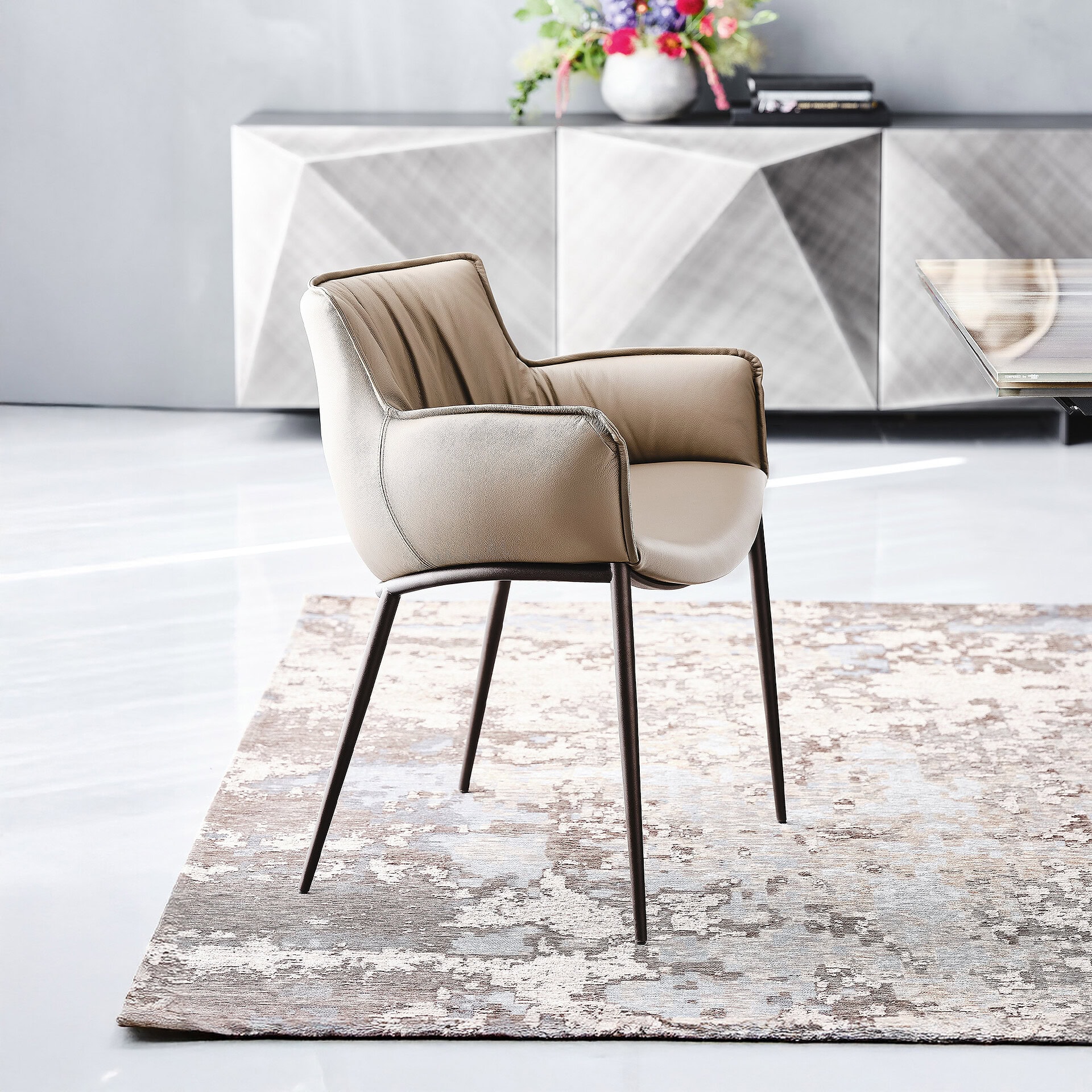Rhonda Dining Chair in light beige leather with soft upholstery and bronze finish legs.