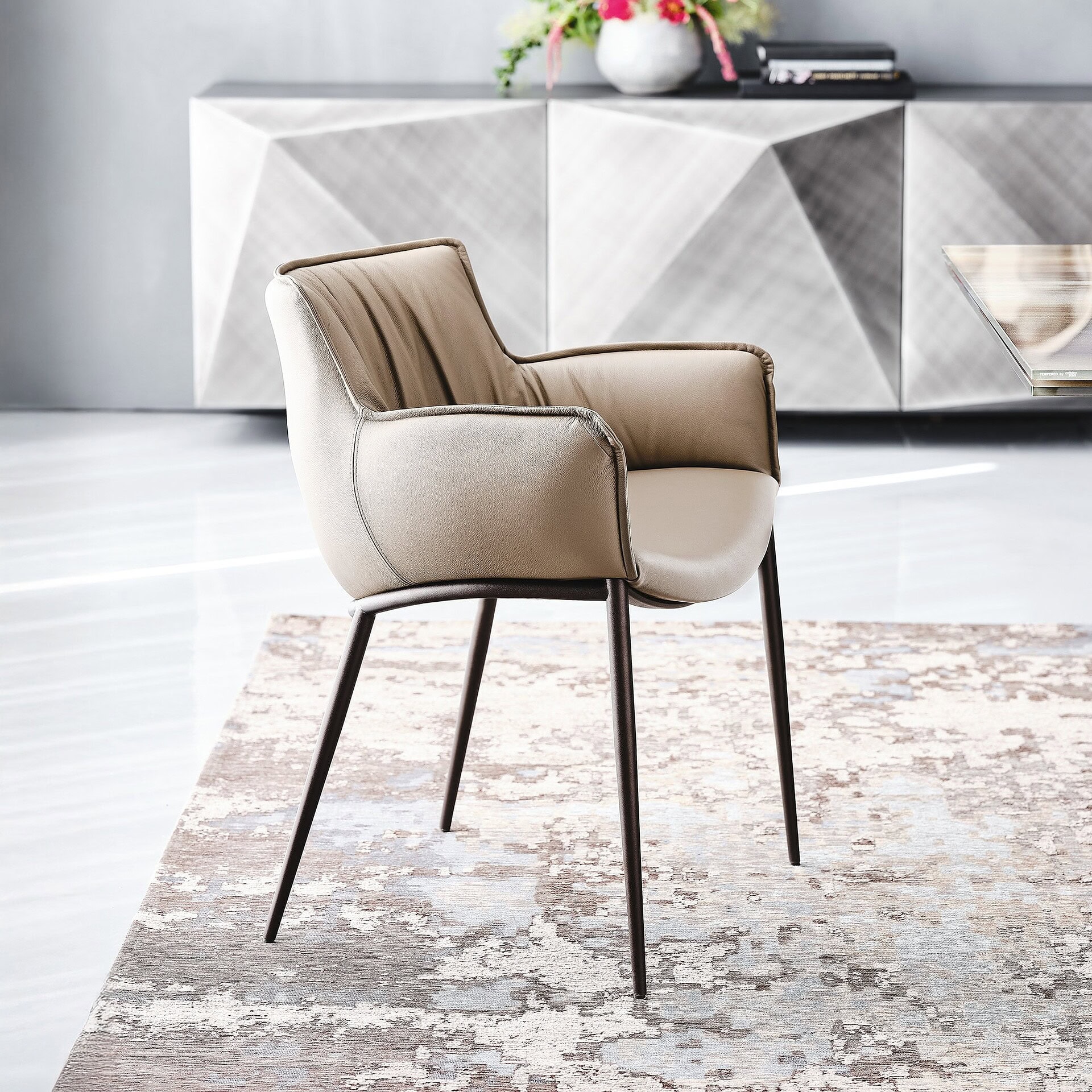 Rhonda Dining Chair in light beige leather with soft upholstery and bronze finish legs.