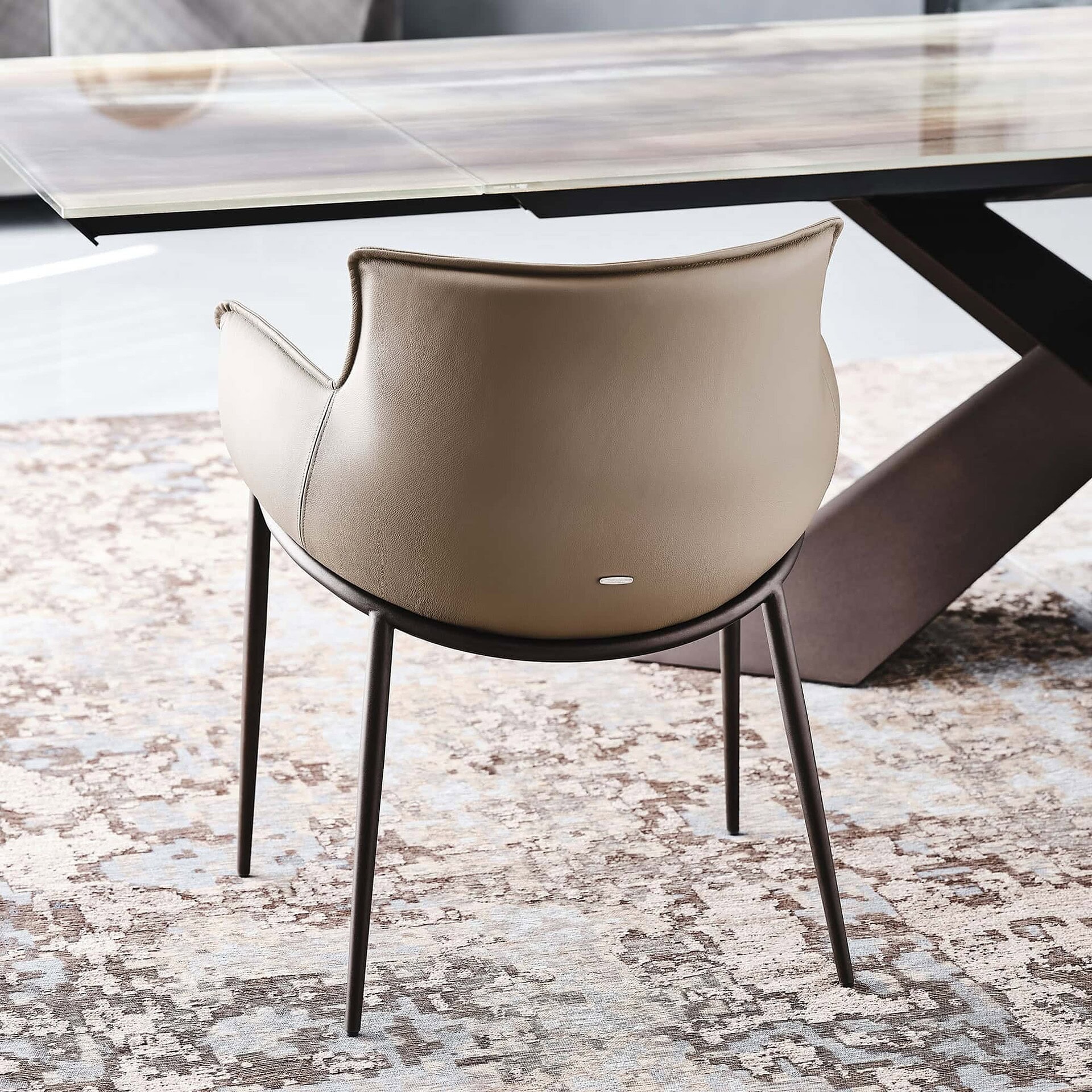 Rear view of the Rhonda Dining Chair showcasing its curved back and tailored leather finish.