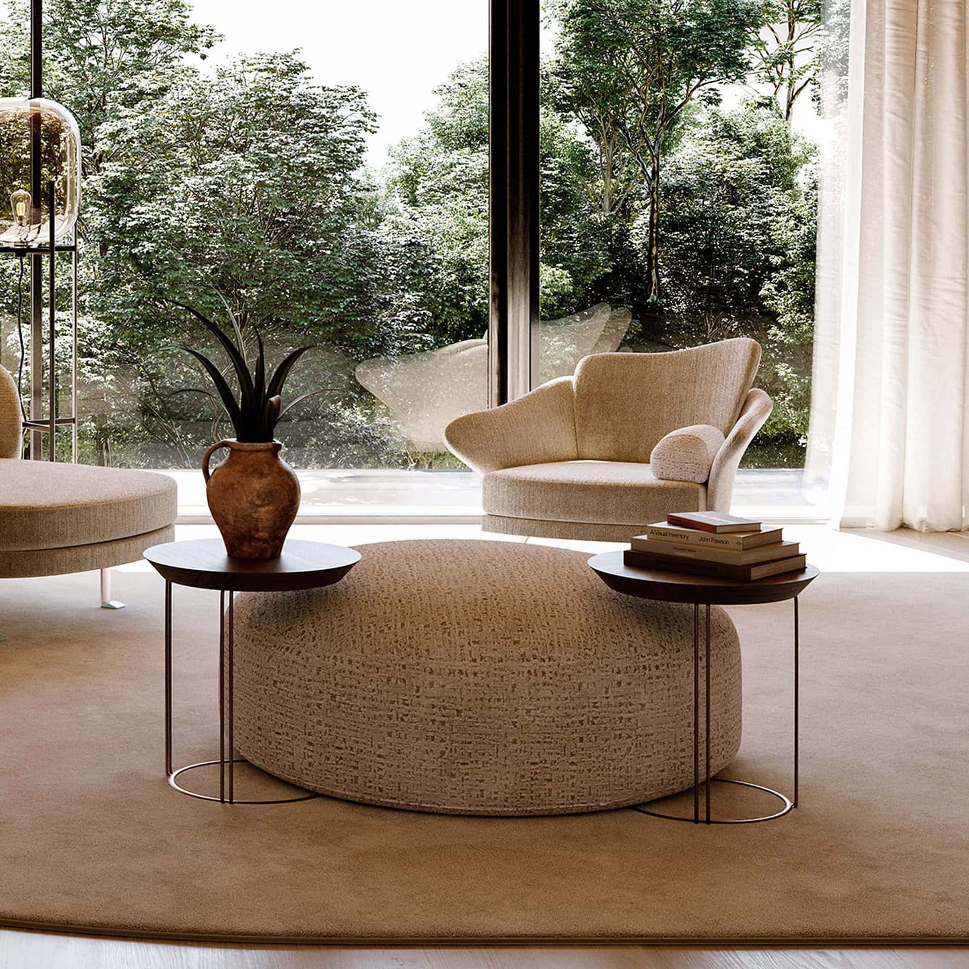 Pair of Flower Armchairs in neutral beige upholstery placed in a modern living room with round ottoman coffee table
