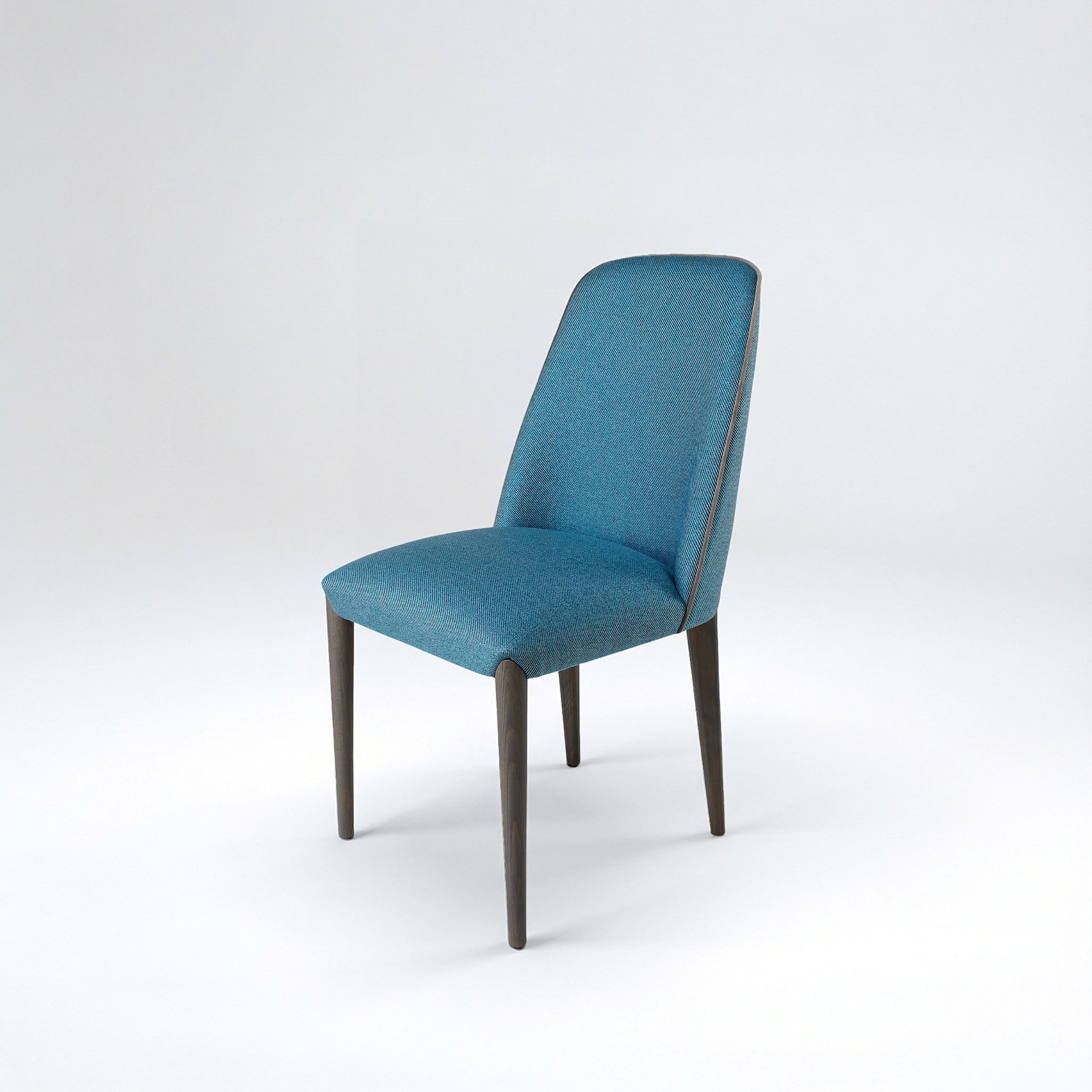 A modern teal upholstered dining chair with dark wooden legs and light brown piping, set against a light gray background.