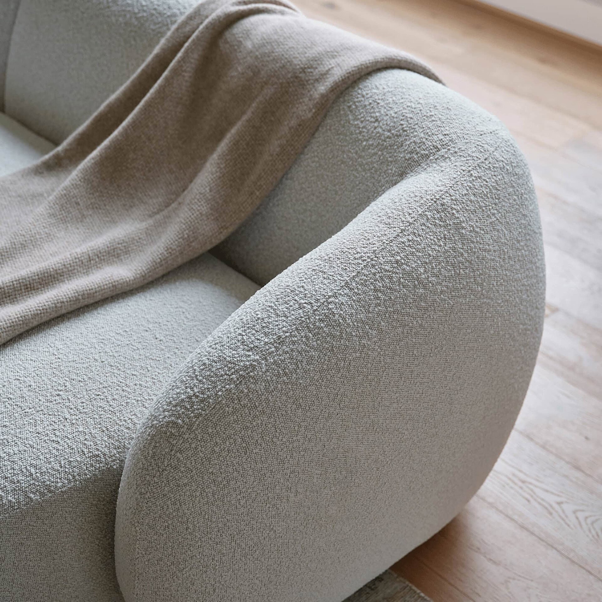 Angled close-up of the Athlea Sofa showing deep cushions and stitching details.