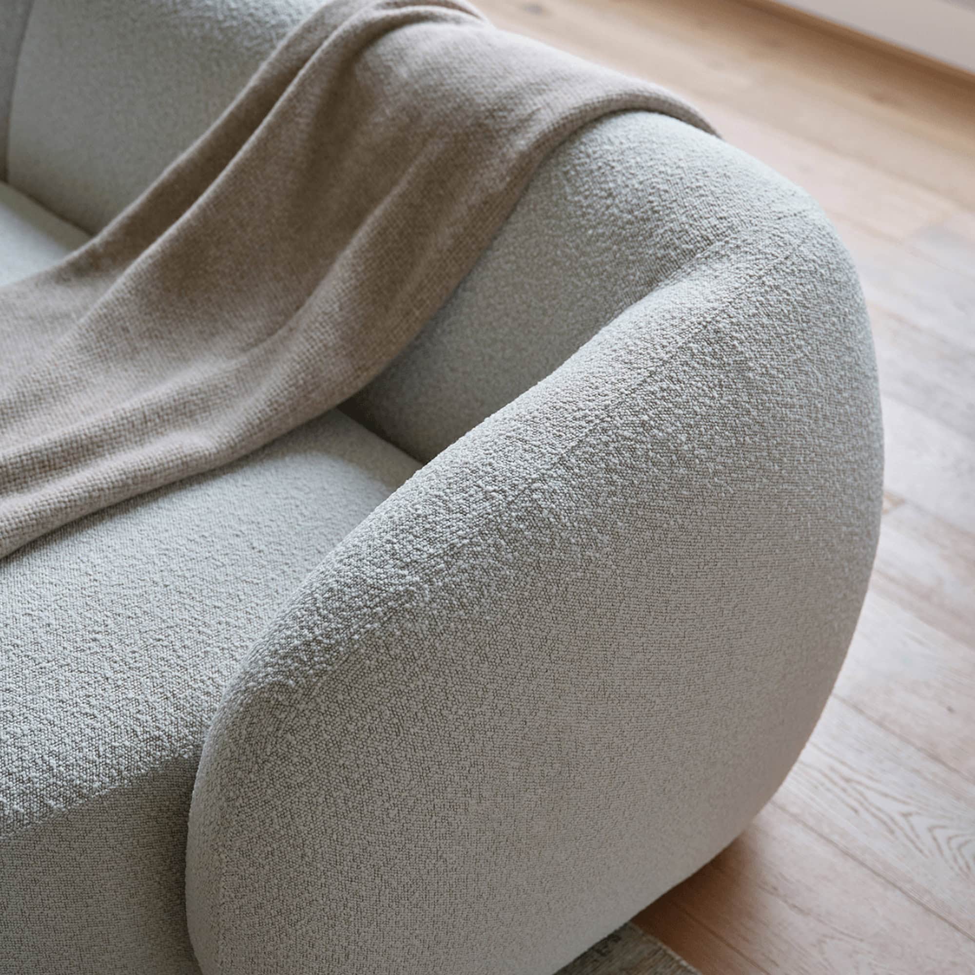 Angled close-up of the Athlea Sofa showing deep cushions and stitching details.