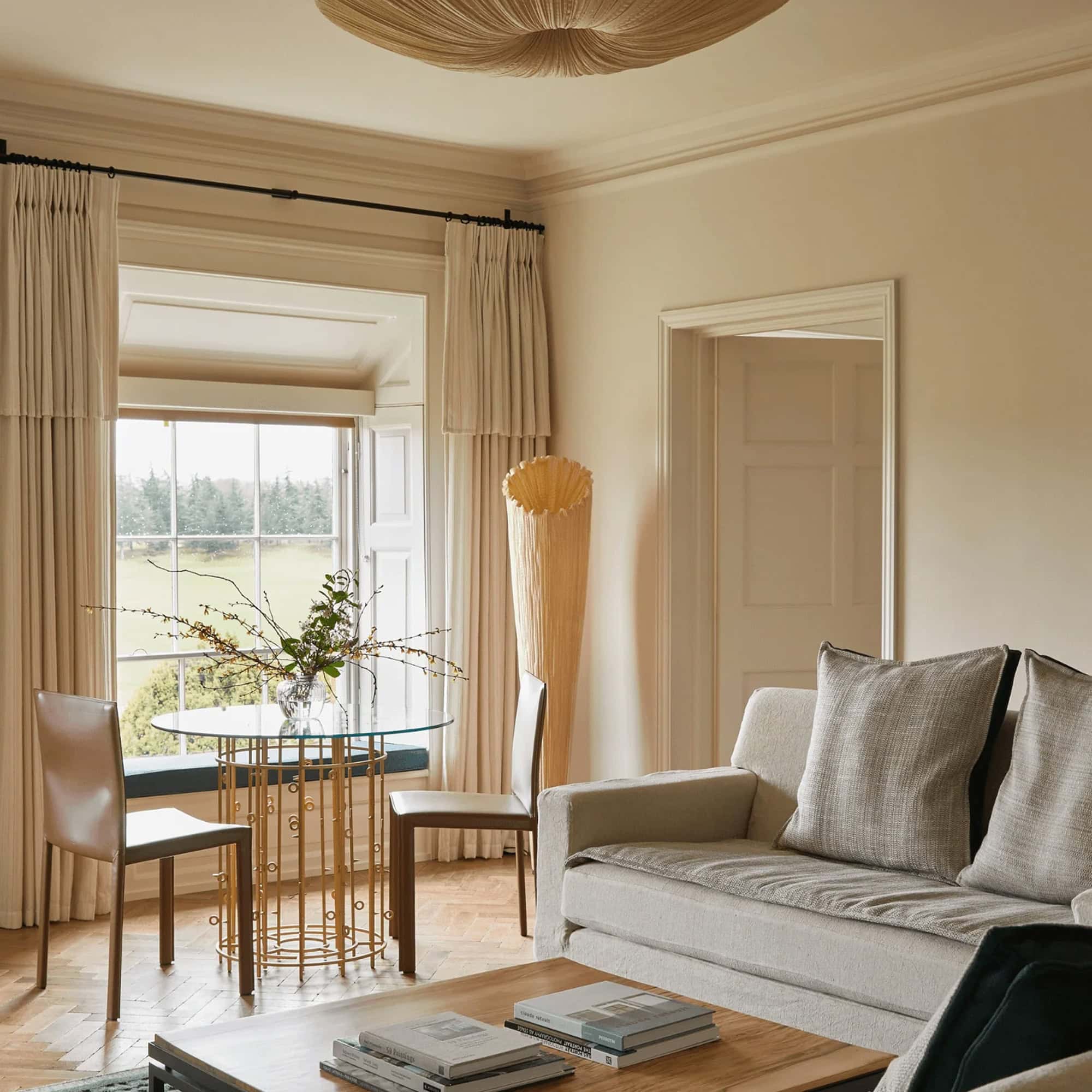 Horn Floor Lamp by Aqua Creations styled in a bright living room with neutral furniture.