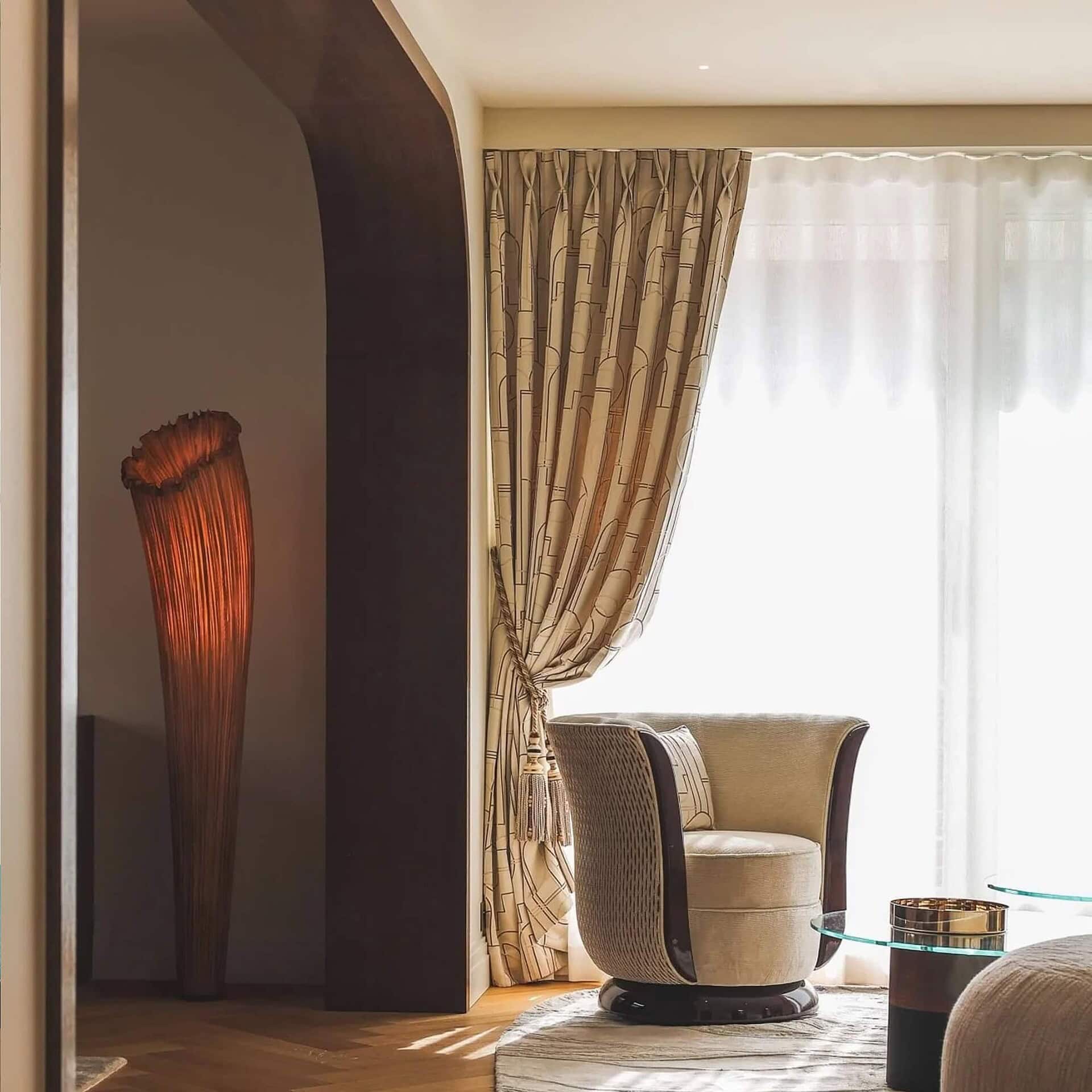 Horn Silk Floor Lamp by Aqua Creations showcased in a sophisticated interior with draped curtains.