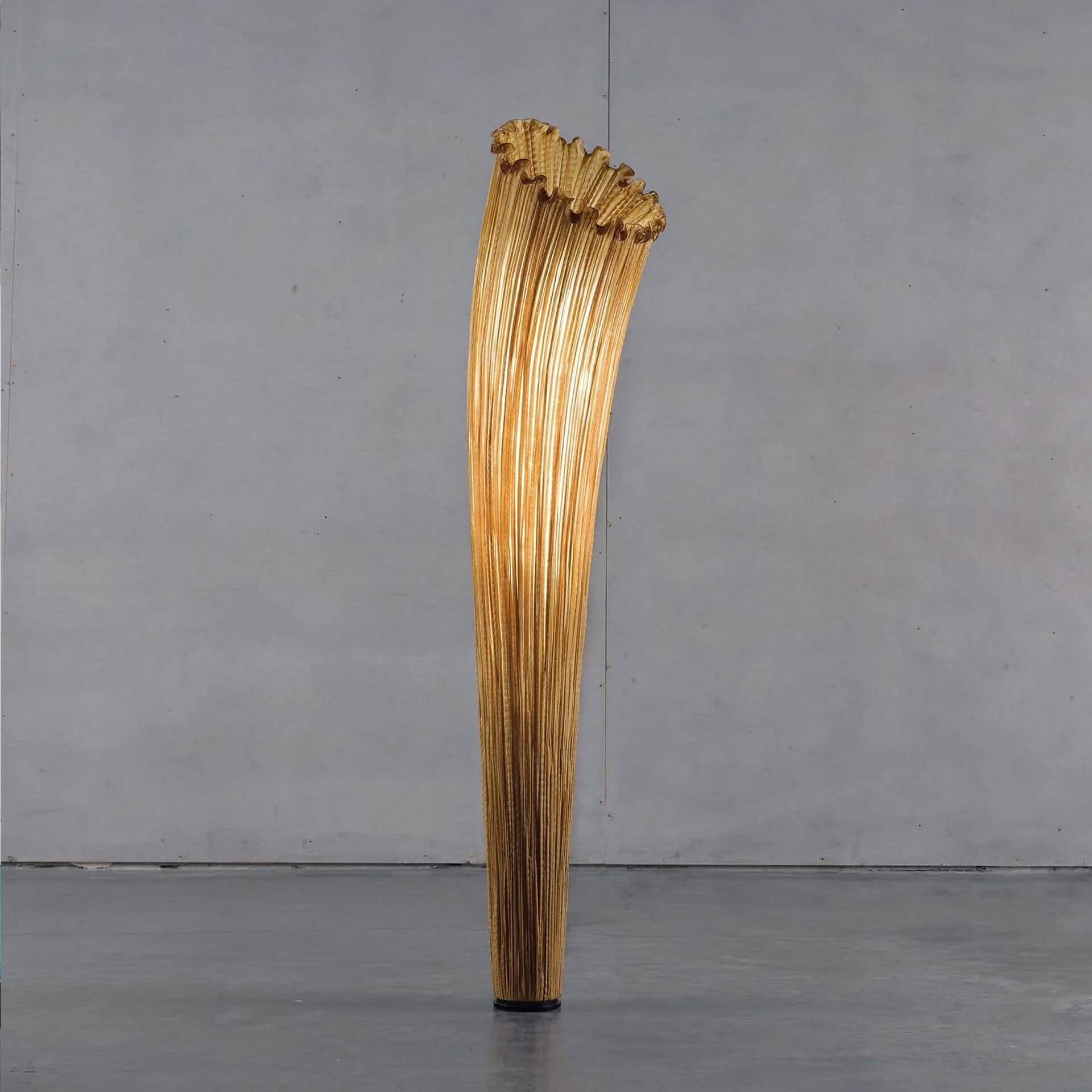 Close-up view of the Aqua Creations Horn Silk Floor Lamp in golden silk finish, highlighting its sculptural design.