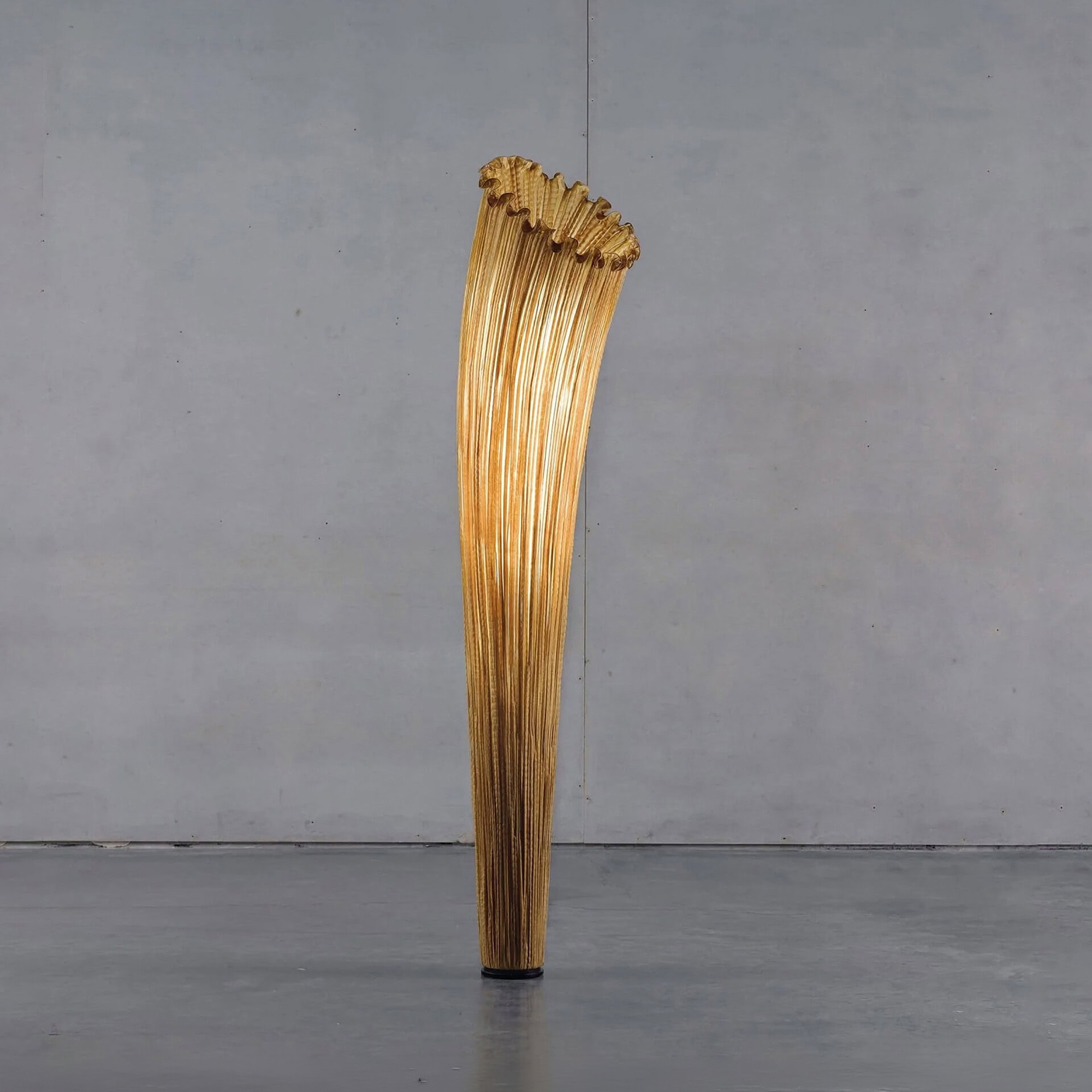 Close-up view of the Aqua Creations Horn Silk Floor Lamp in golden silk finish, highlighting its sculptural design.