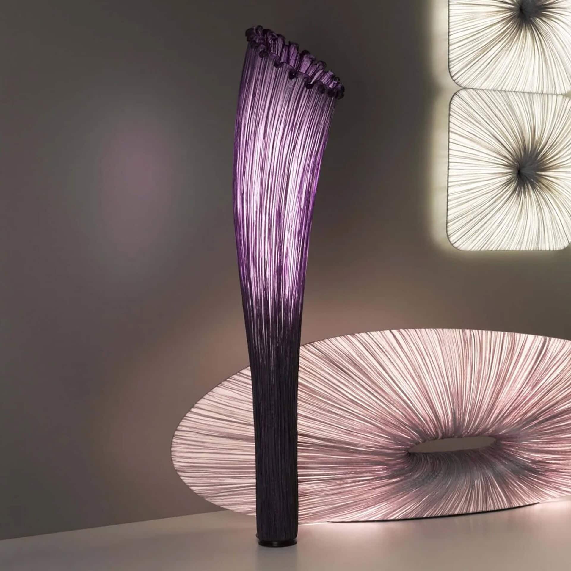 Horn Silk Floor Lamp by Aqua Creations in purple silk shade, glowing softly in a modern setting.