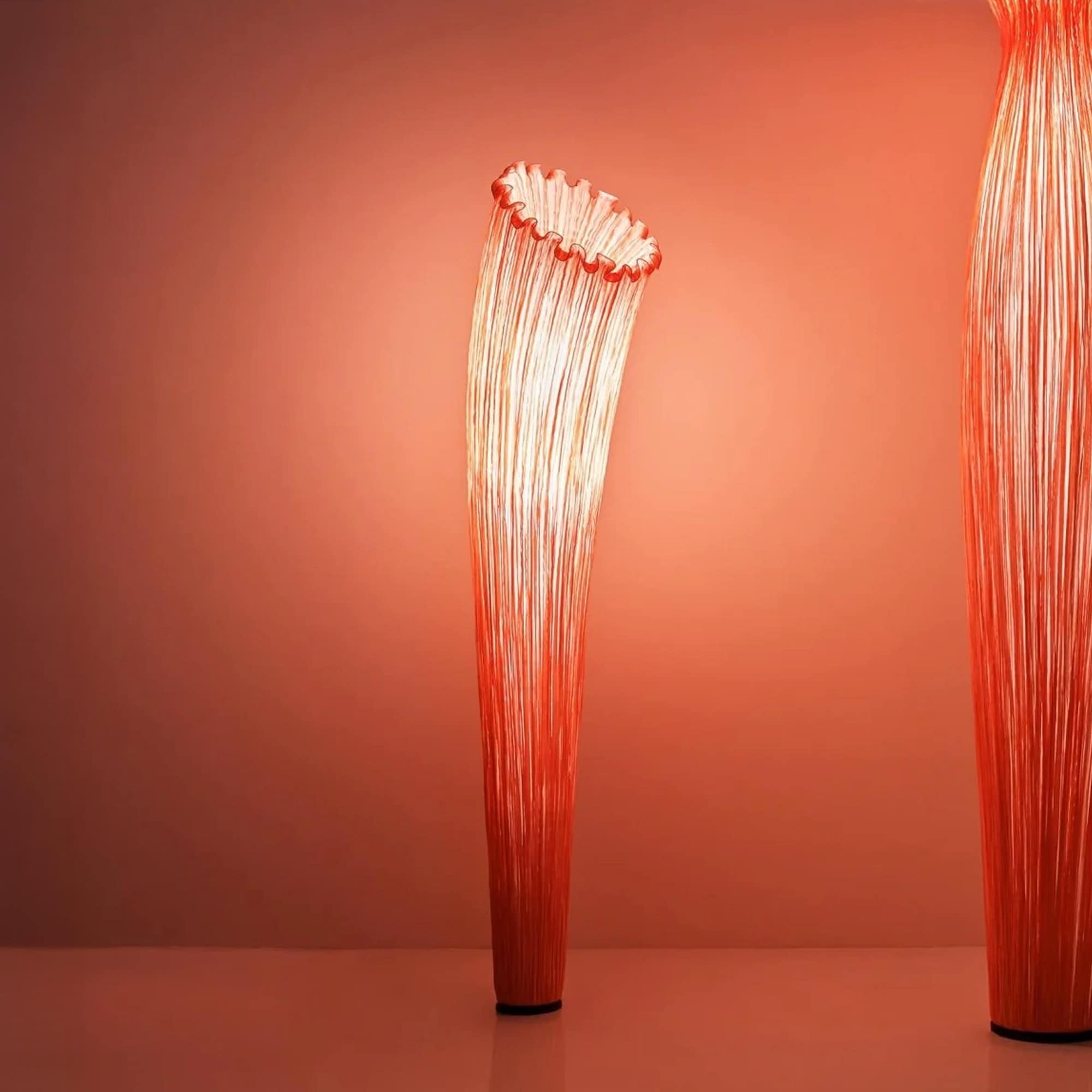 Aqua Creations Horn Floor Lamp in bold red silk, adding drama to an interior space.