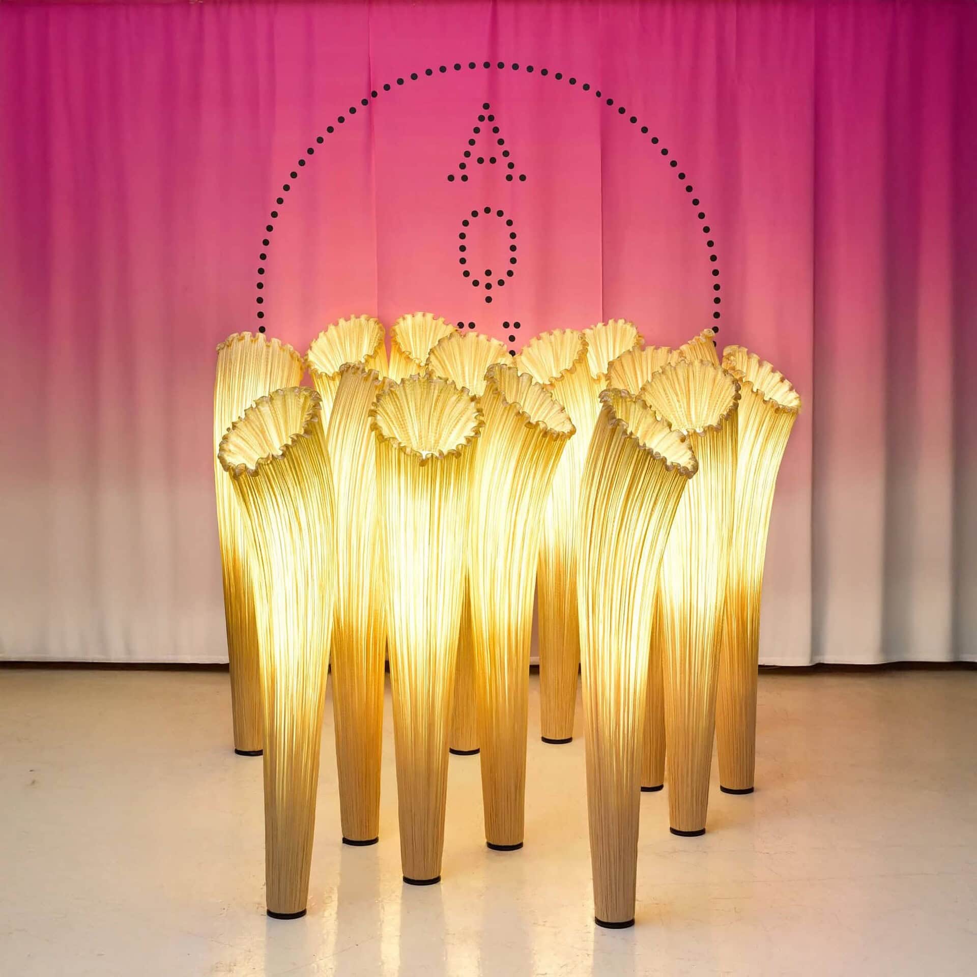 Group of Aqua Creations Horn Silk Floor Lamps in a golden silk finish arranged together in a display.