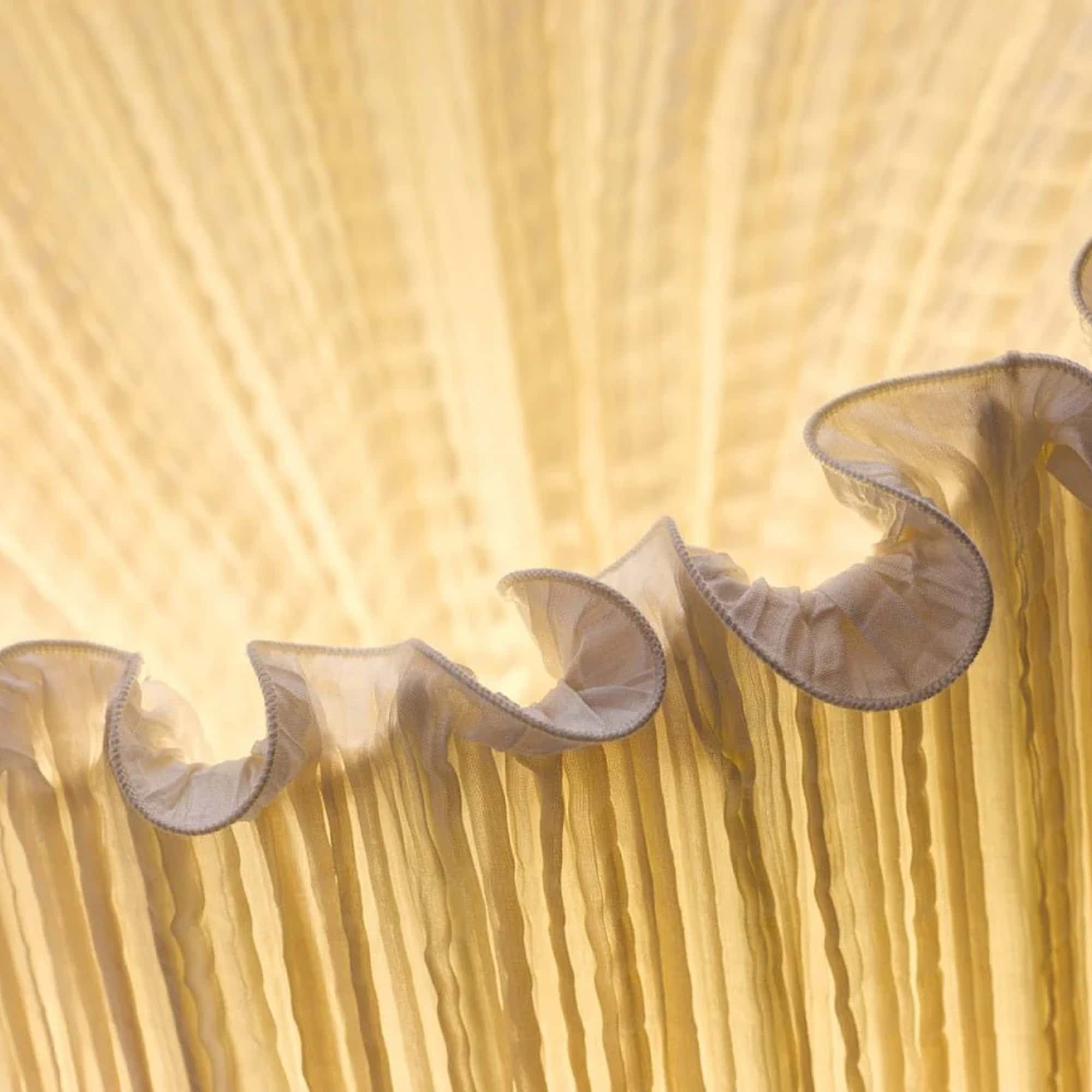 Group of Aqua Creations Horn Floor Lamps in a golden silk finish arranged together in a display.