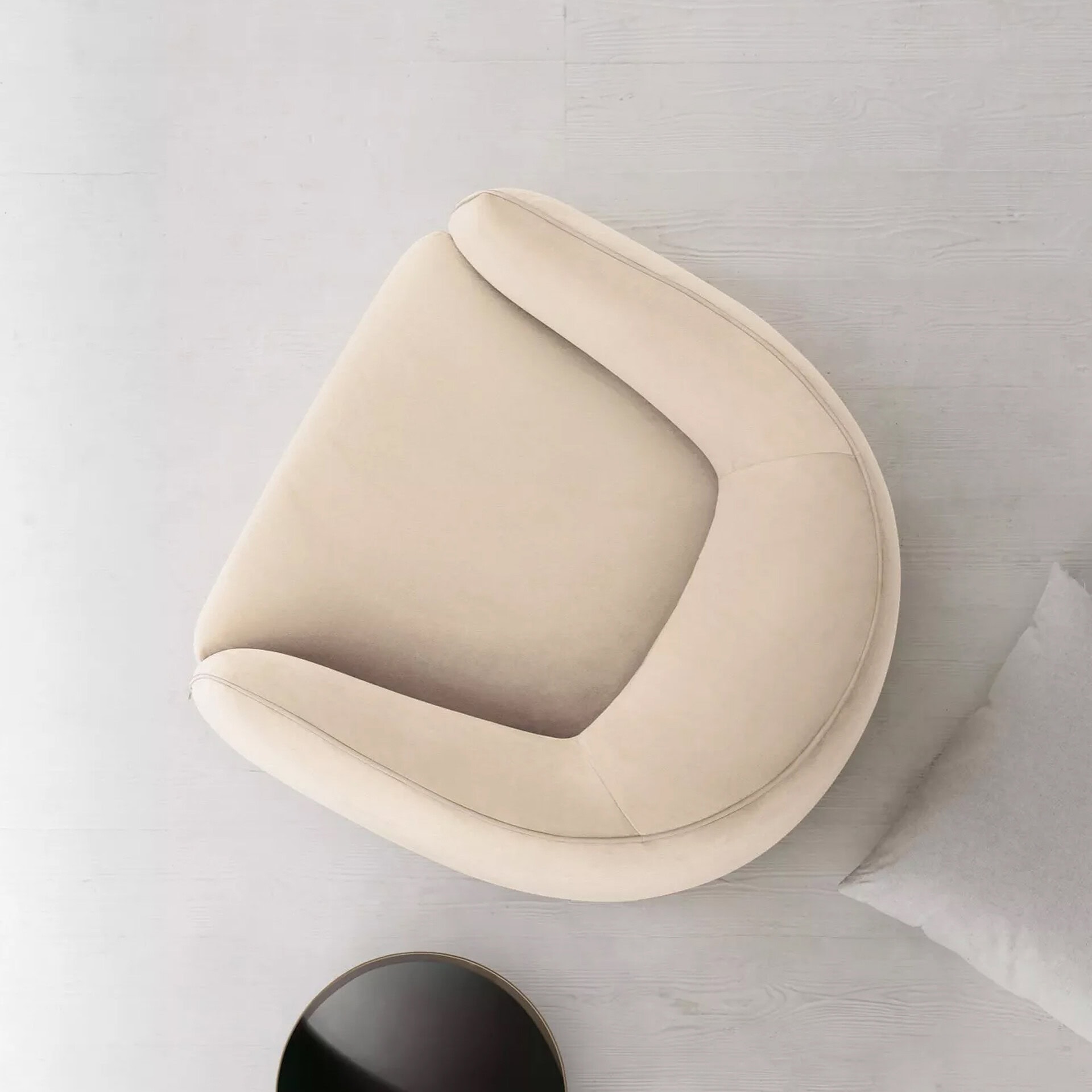 Elegant beige armchair with smooth curves, perfect for modern interior decor.