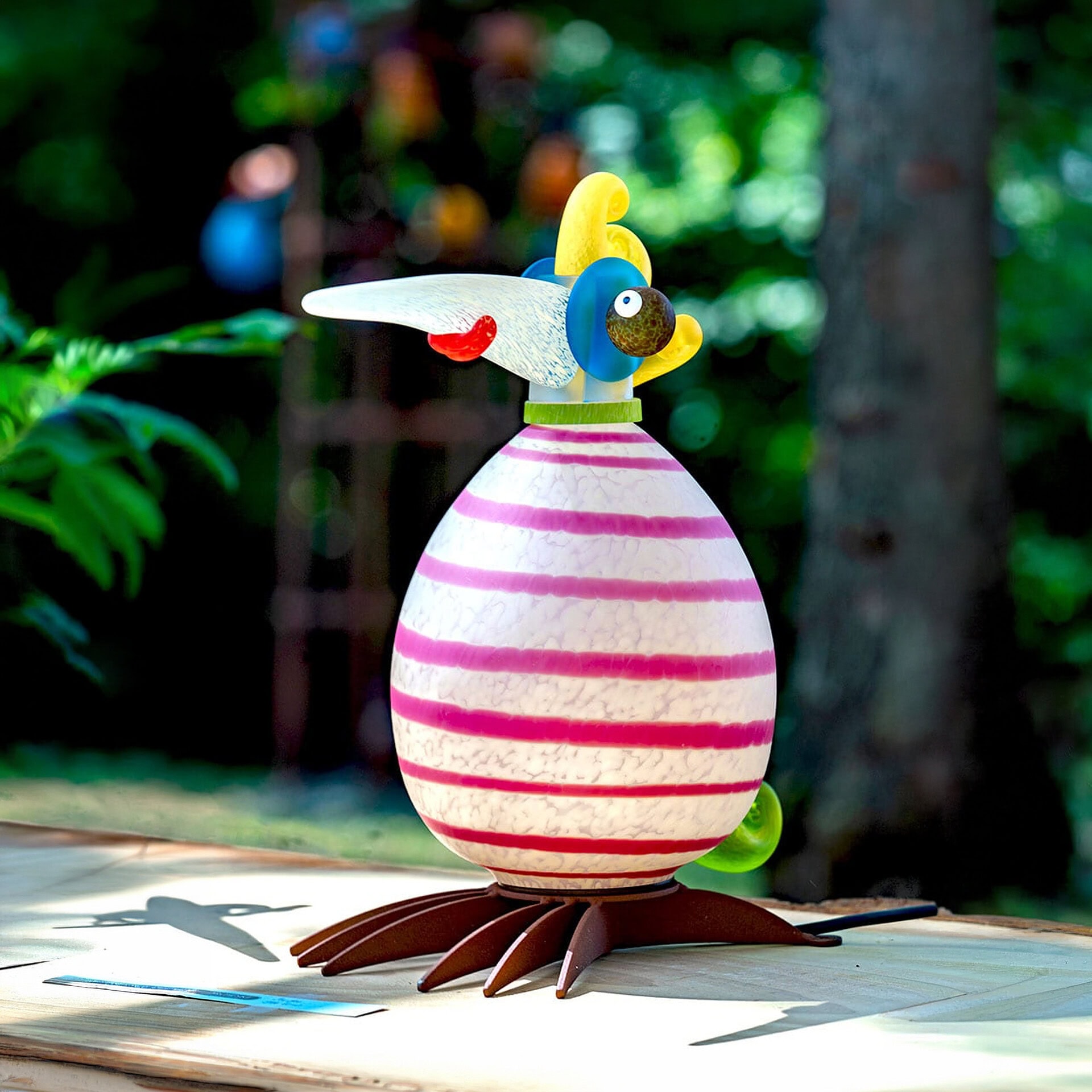 Outdoor bird-shaped light sculpture for garden decor.