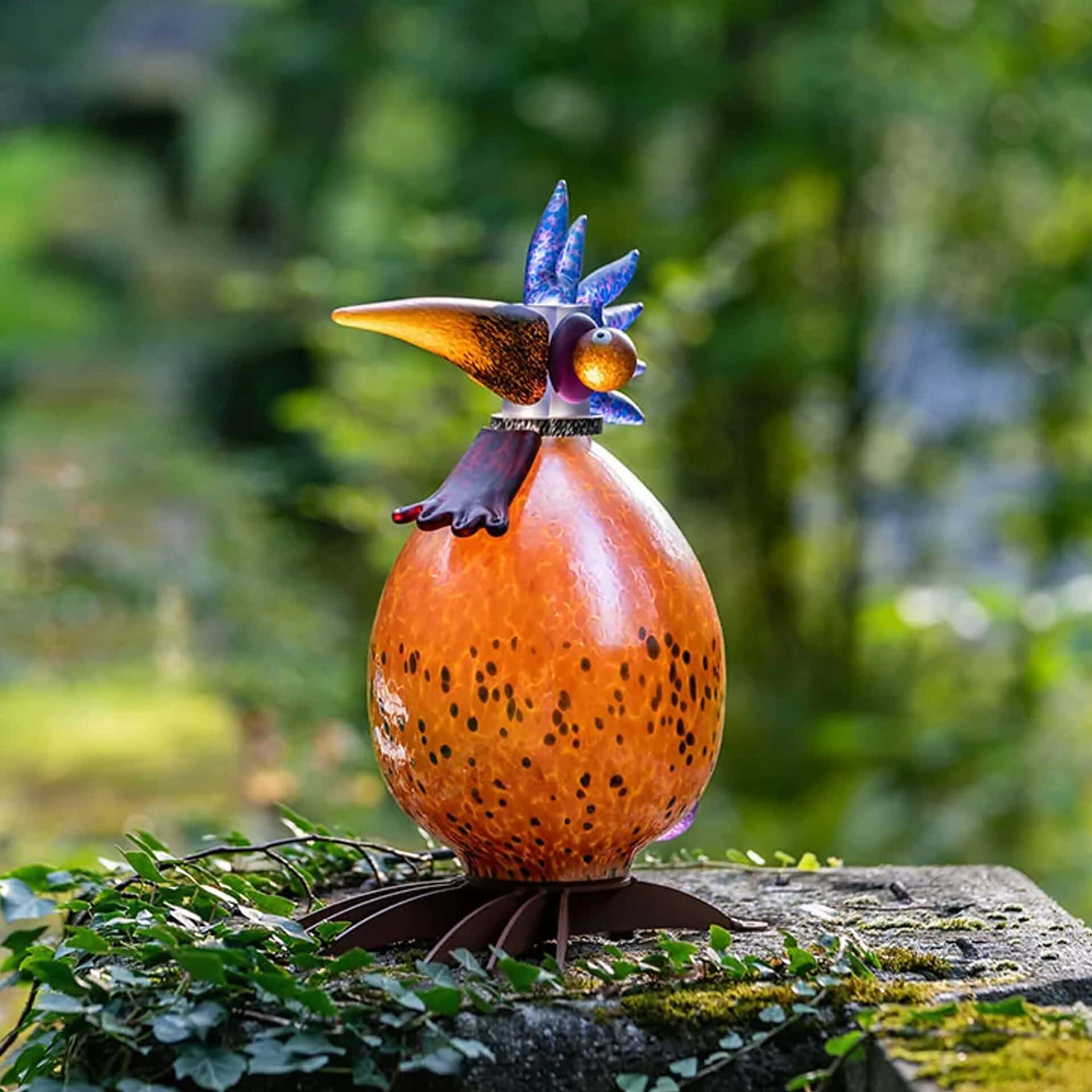 Outdoor bird sculpture with colorful metal design, perfect for garden lighting.