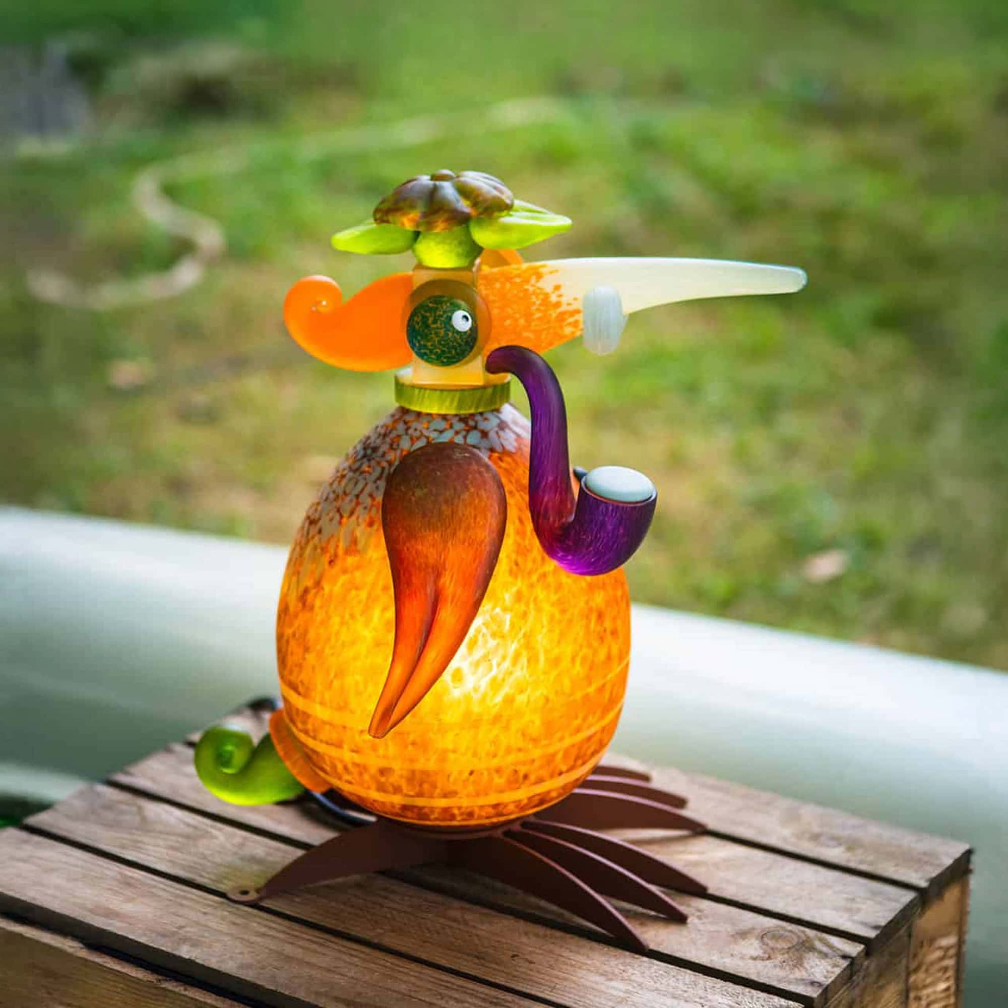 Colorful outdoor bird sculpture with whimsical design, perfect for garden decor.