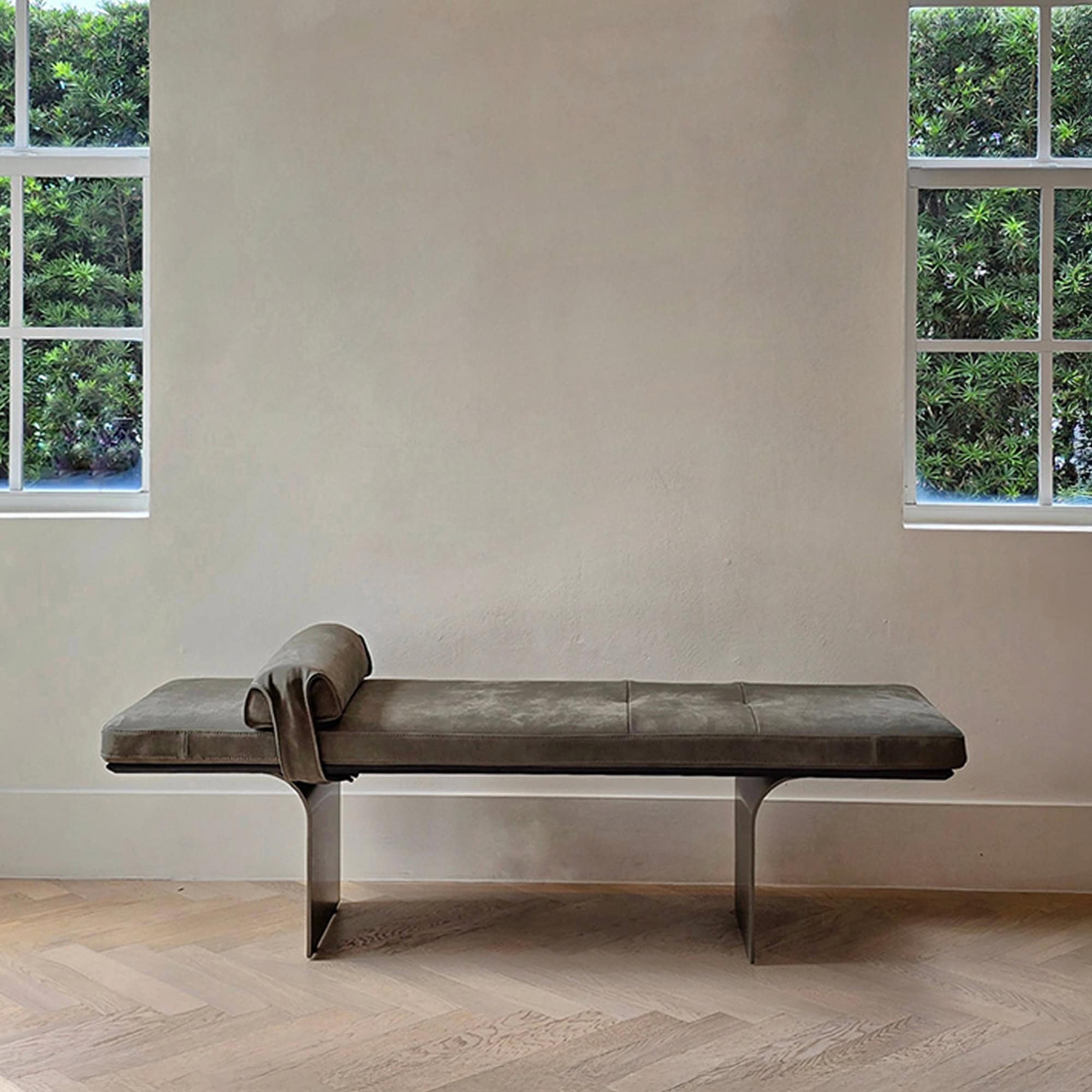 Minerva Leather Bench upholstered in neutral fabric against a textured wall with windows.