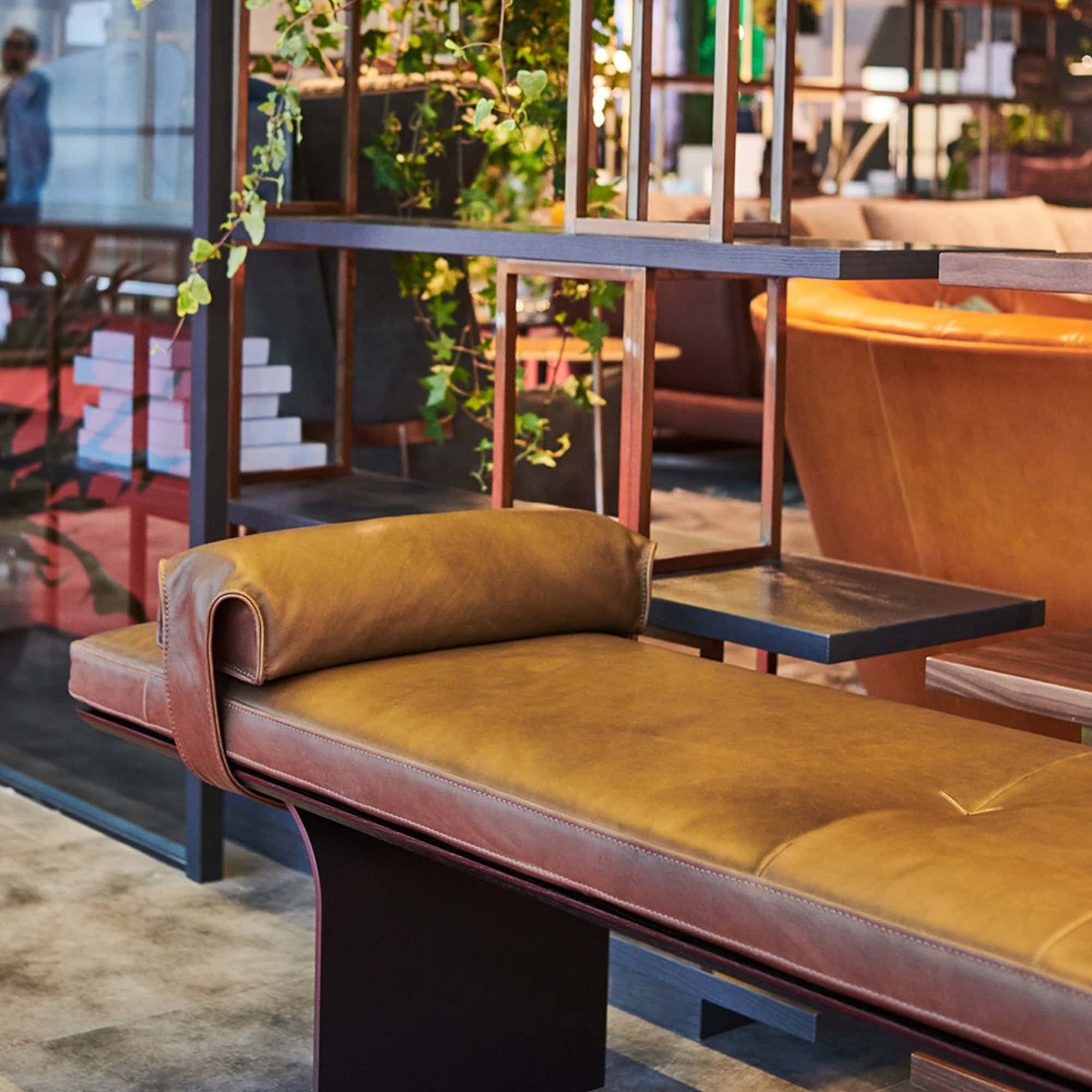 Close-up view of Minerva Leather Bench in warm brown leather upholstery in hospitality setting.