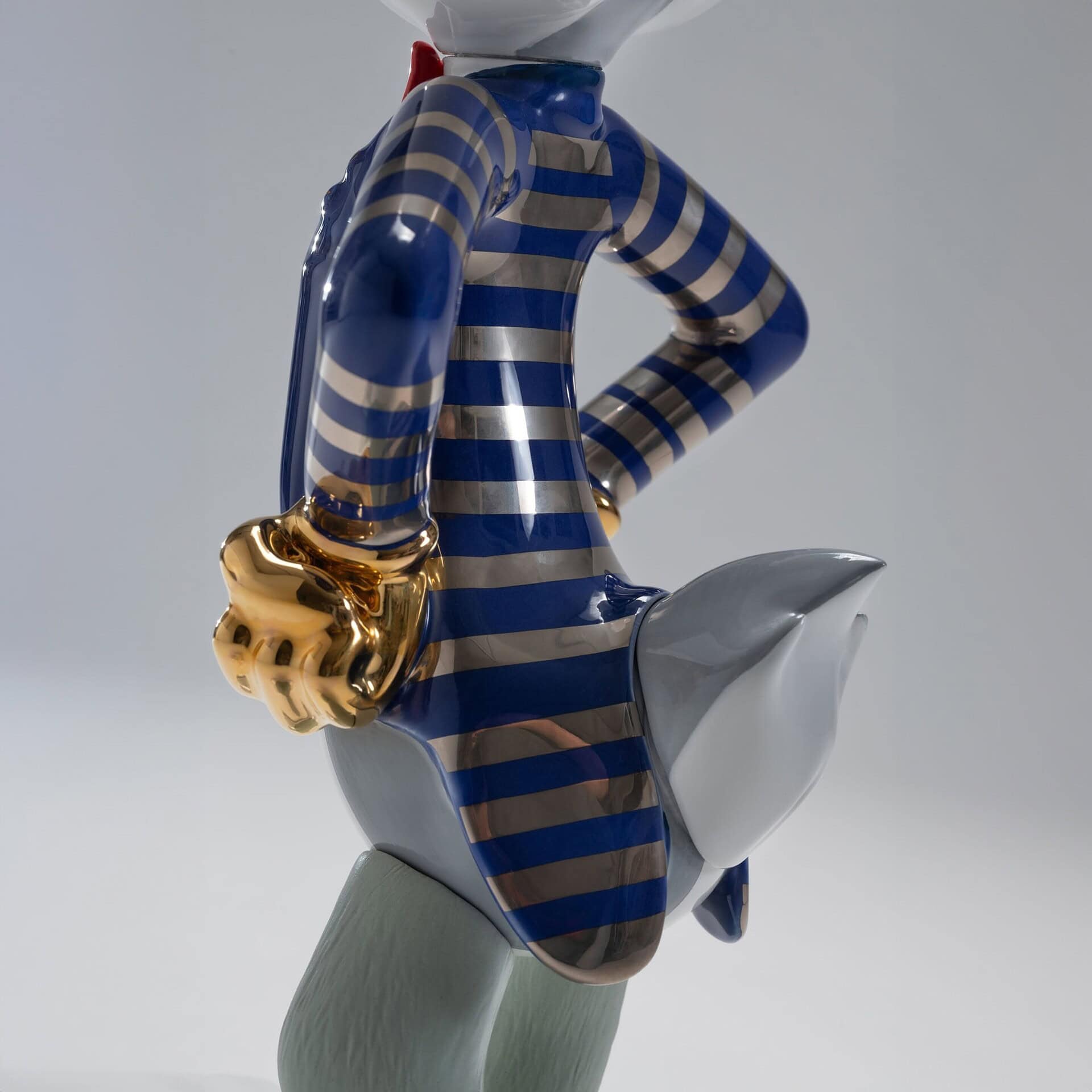 Close-up of The Shiny Bugs Pop Art Sculpture jacket detail, highlighting gold-gloved hands and metallic enamel stripes.