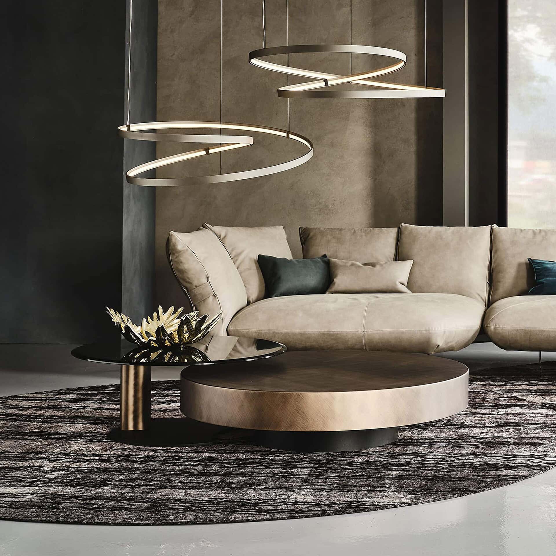 Arena Hand-Brushed Coffee Table in brushed bronze finish paired with sectional seating in a contemporary living space.