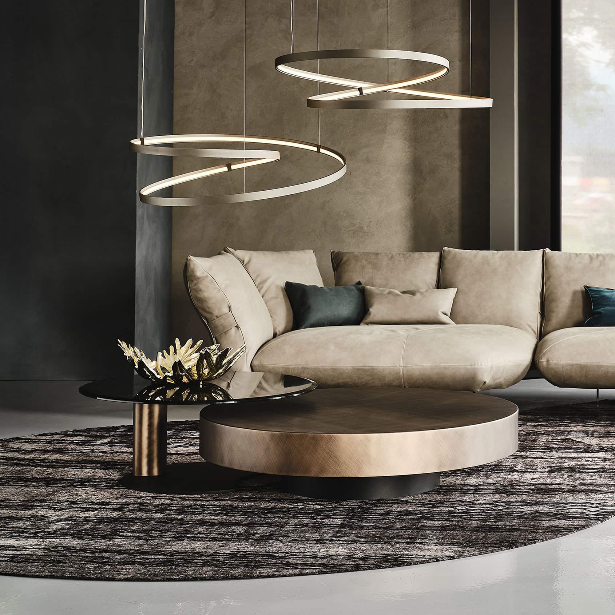 Arena Hand-Brushed Coffee Table in brushed bronze finish paired with sectional seating in a contemporary living space.
