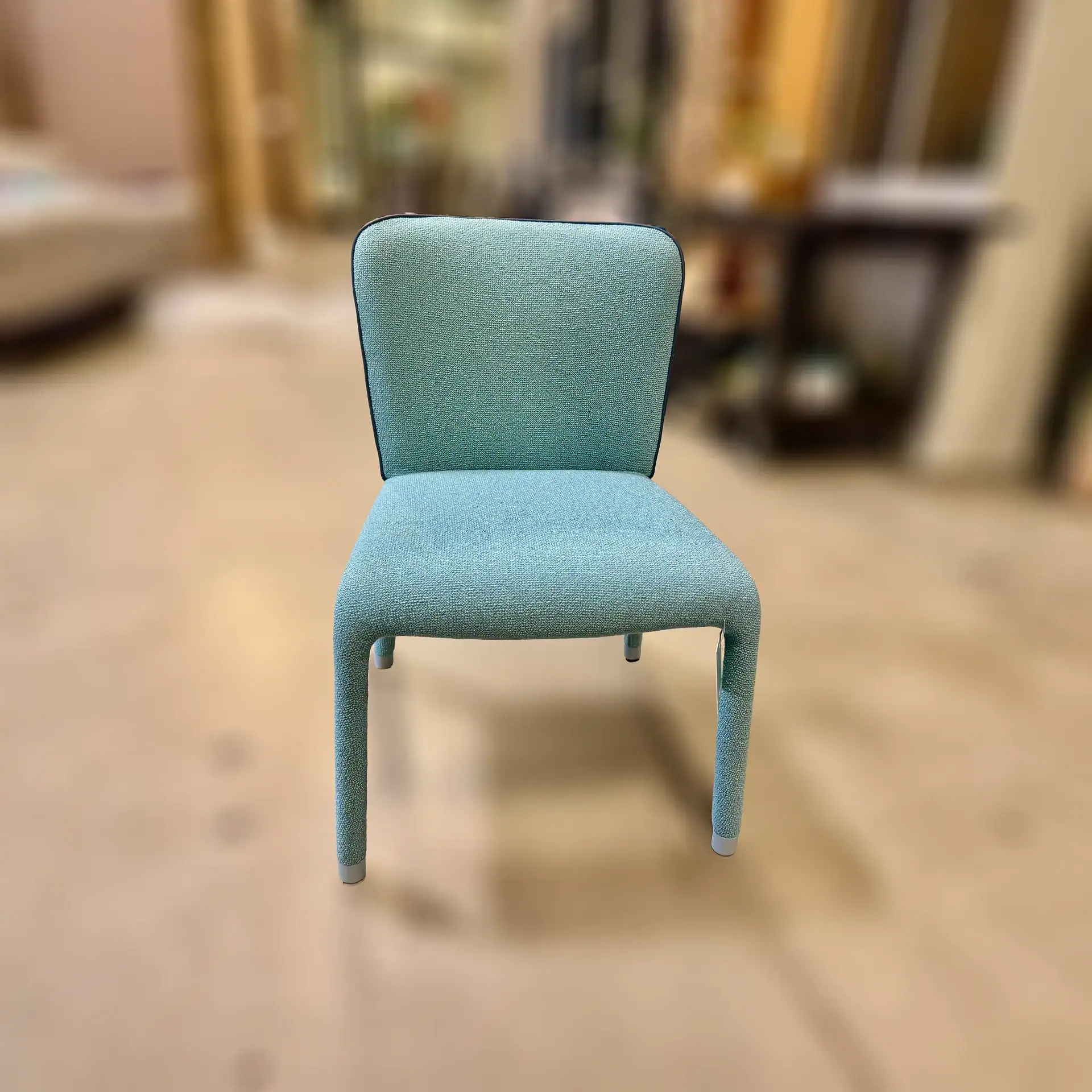 Blue Midj Millier chair with upholstered seat and backrest.