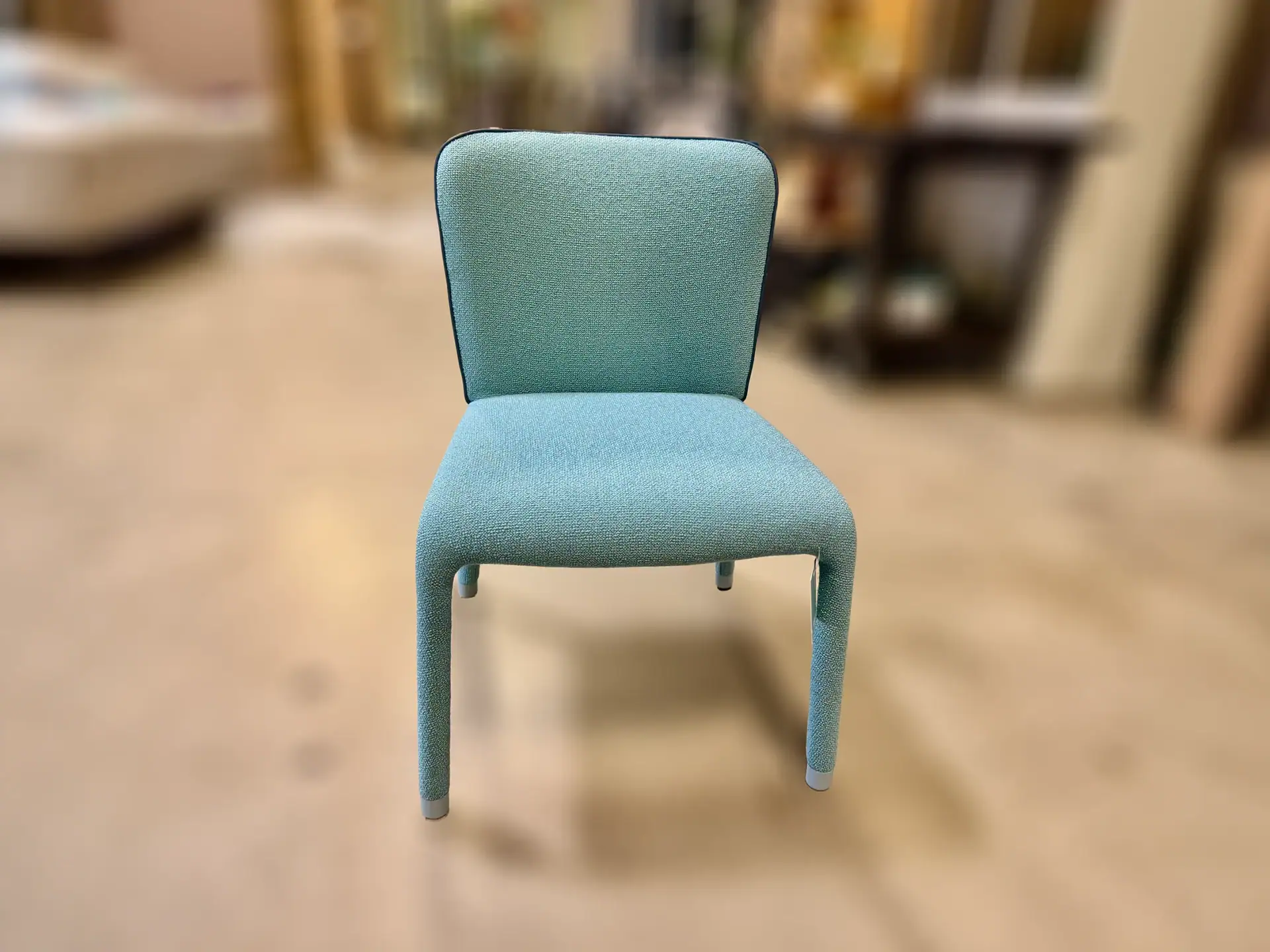 Elegant blue upholstered chair from Sklar Furnishings for modern interiors.