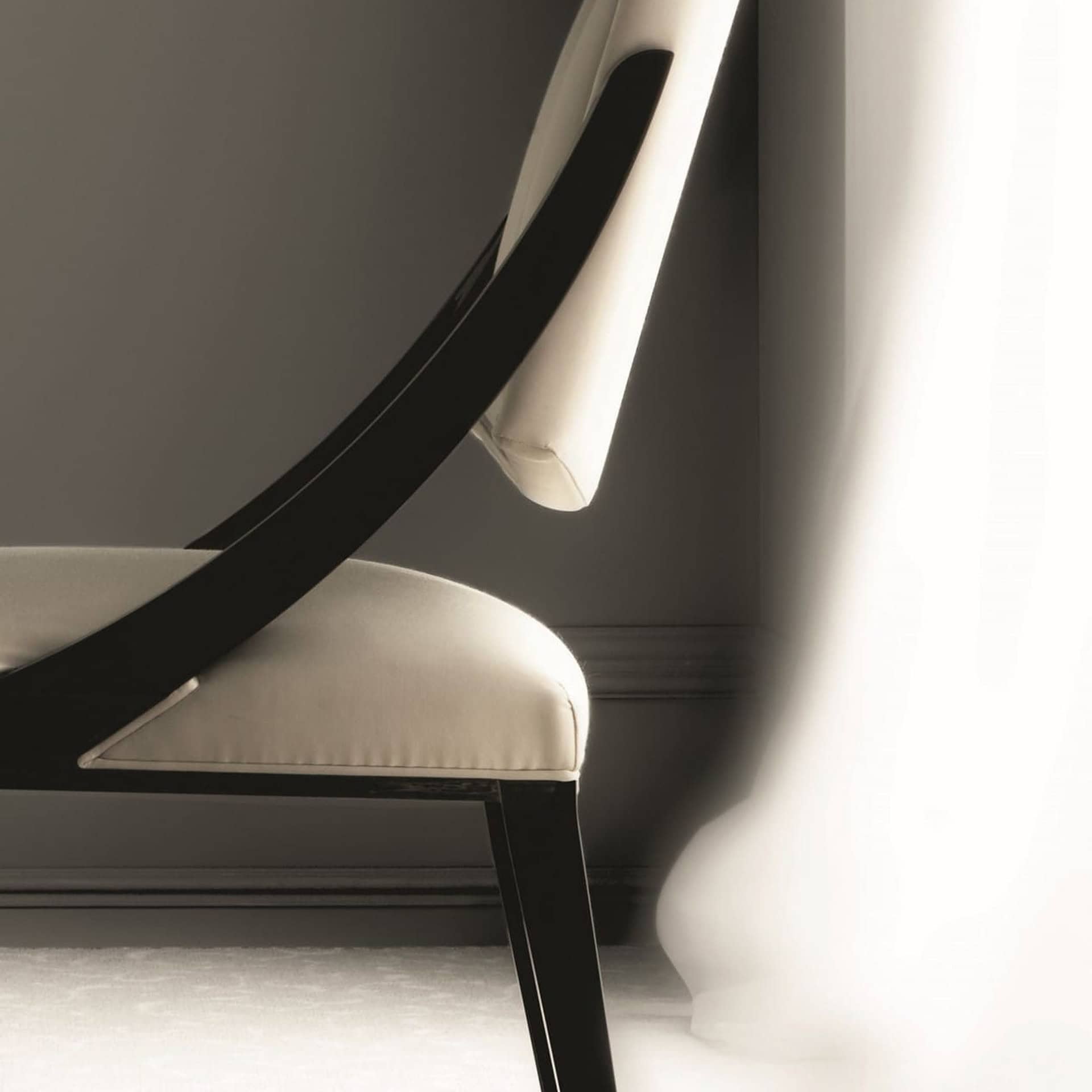 Elegant black and white modern chair with sleek design and comfortable upholstery.
