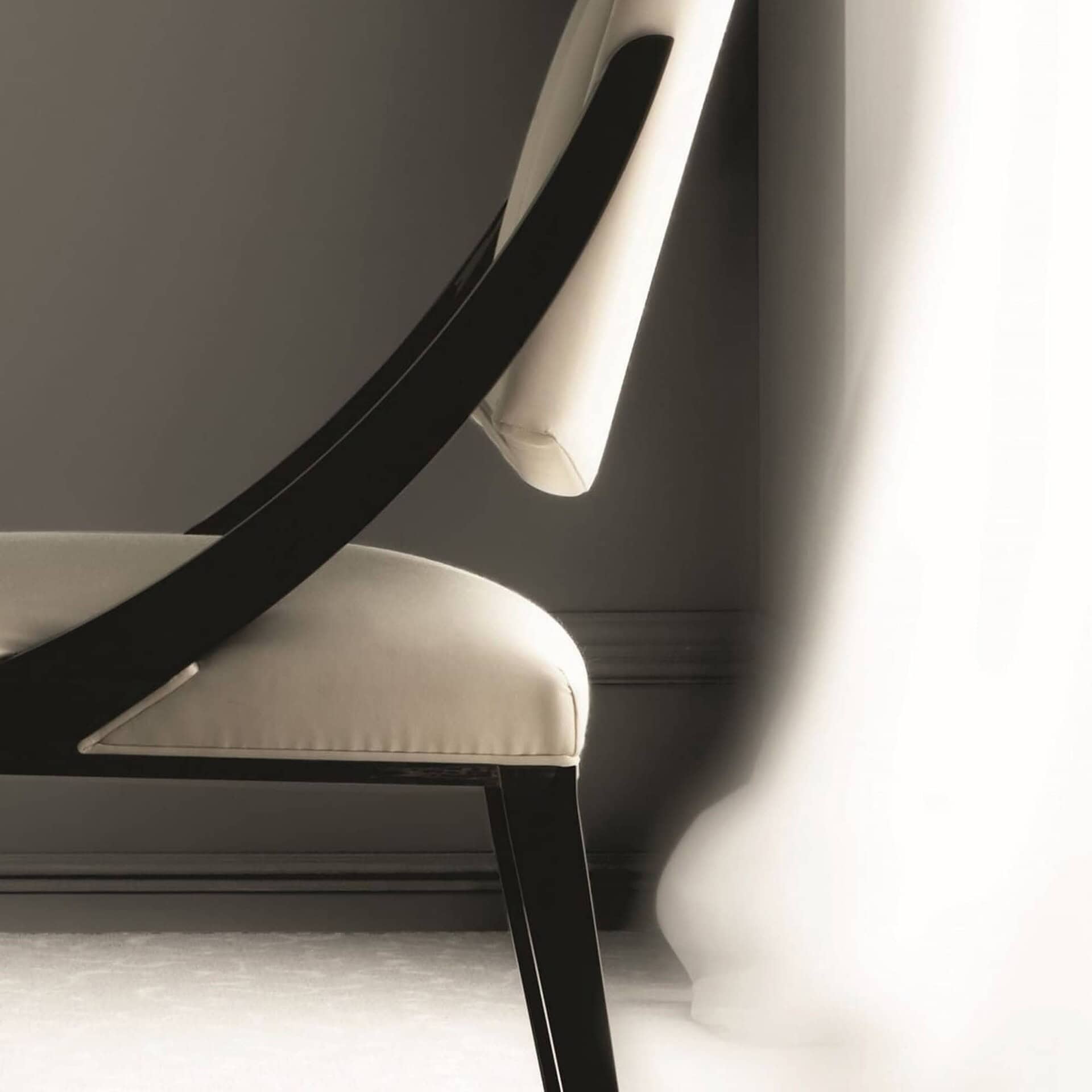 Close-up of the Memory Dining Chair showcasing its upholstered back and sleek wood frame.