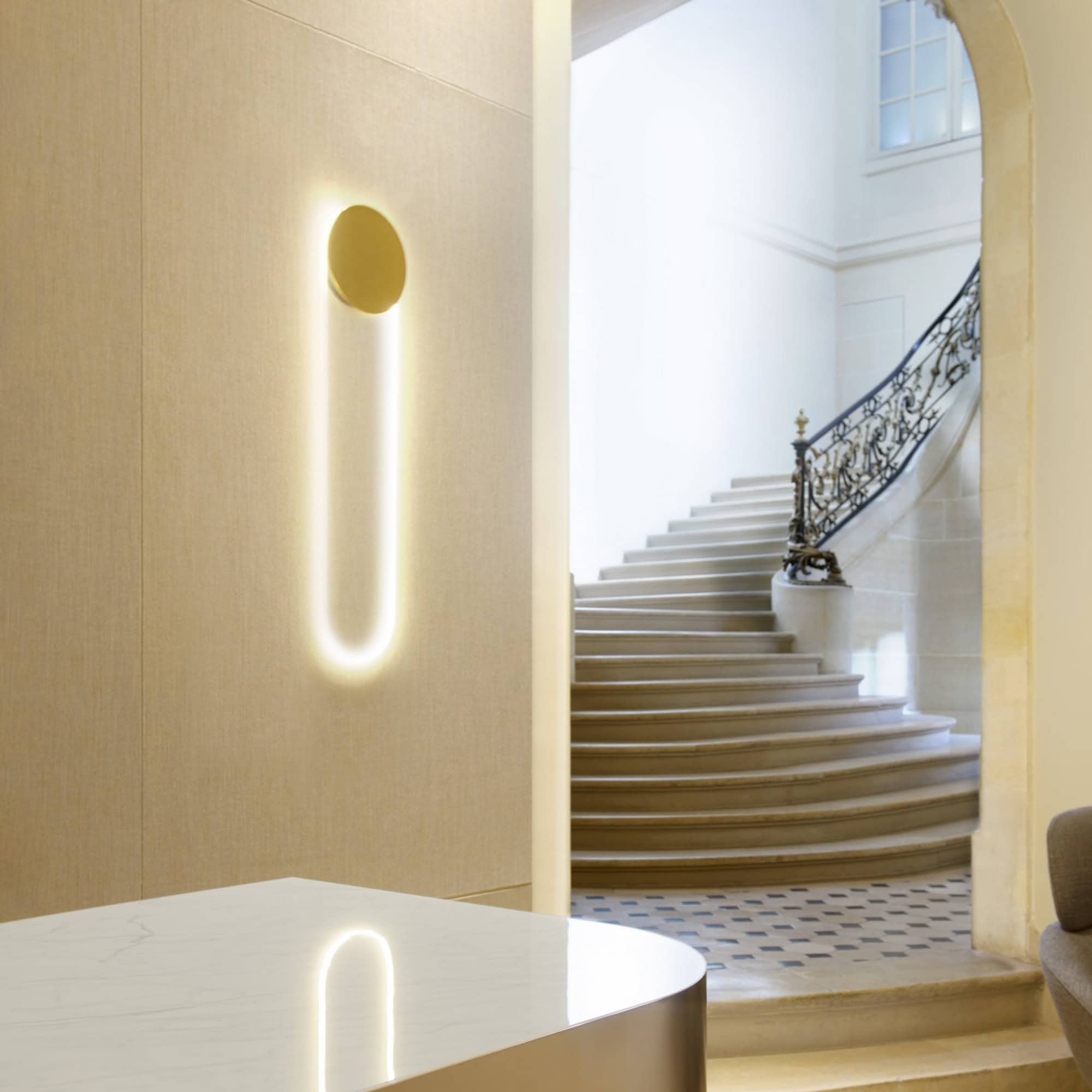 Sleek modern wall light fixture with soft backlit glow in stylish interior space.