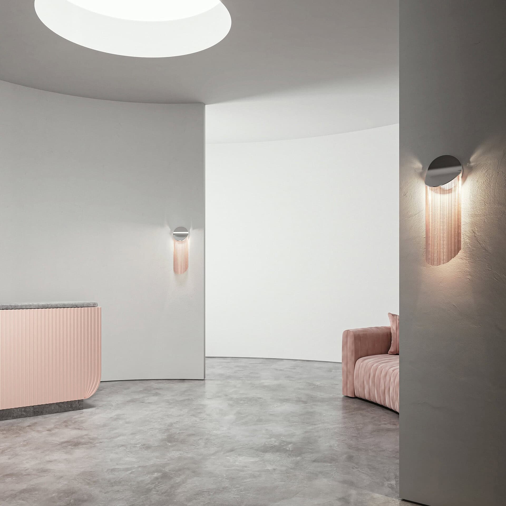 Elegant modern interior featuring pastel pink furnishings and minimalistic lighting.