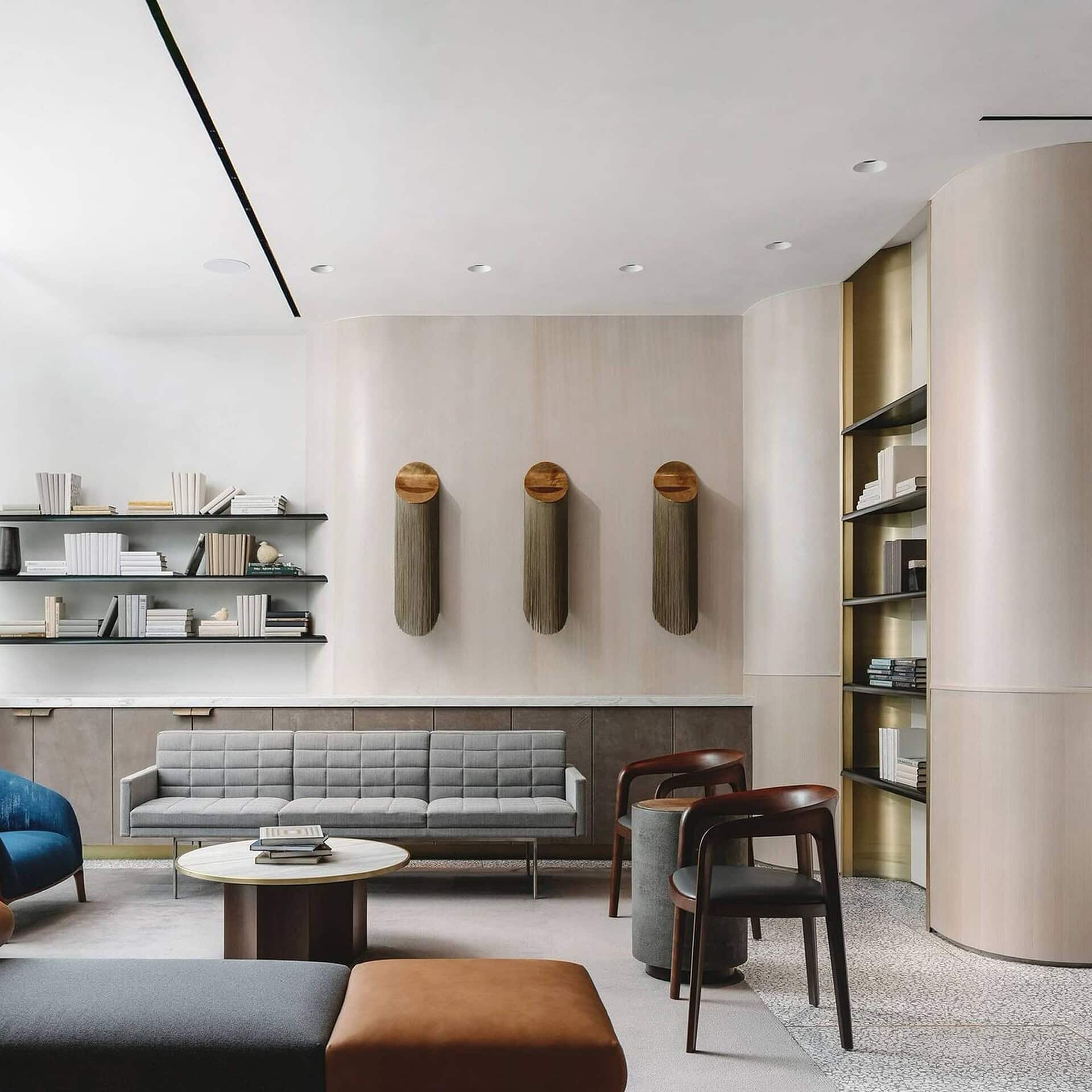 Minimalist modern living room with stylish sofas, unique wall art, and sleek shelving, showcasing elegant interior furniture design.