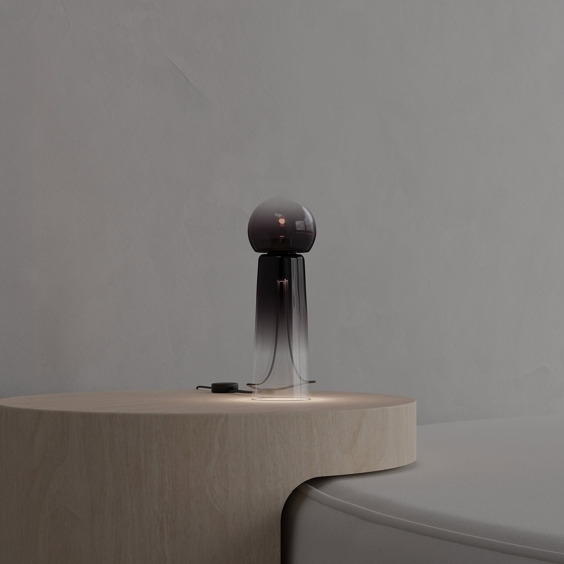 Elevated modern table lamp with a glass and metal design for contemporary home decor.