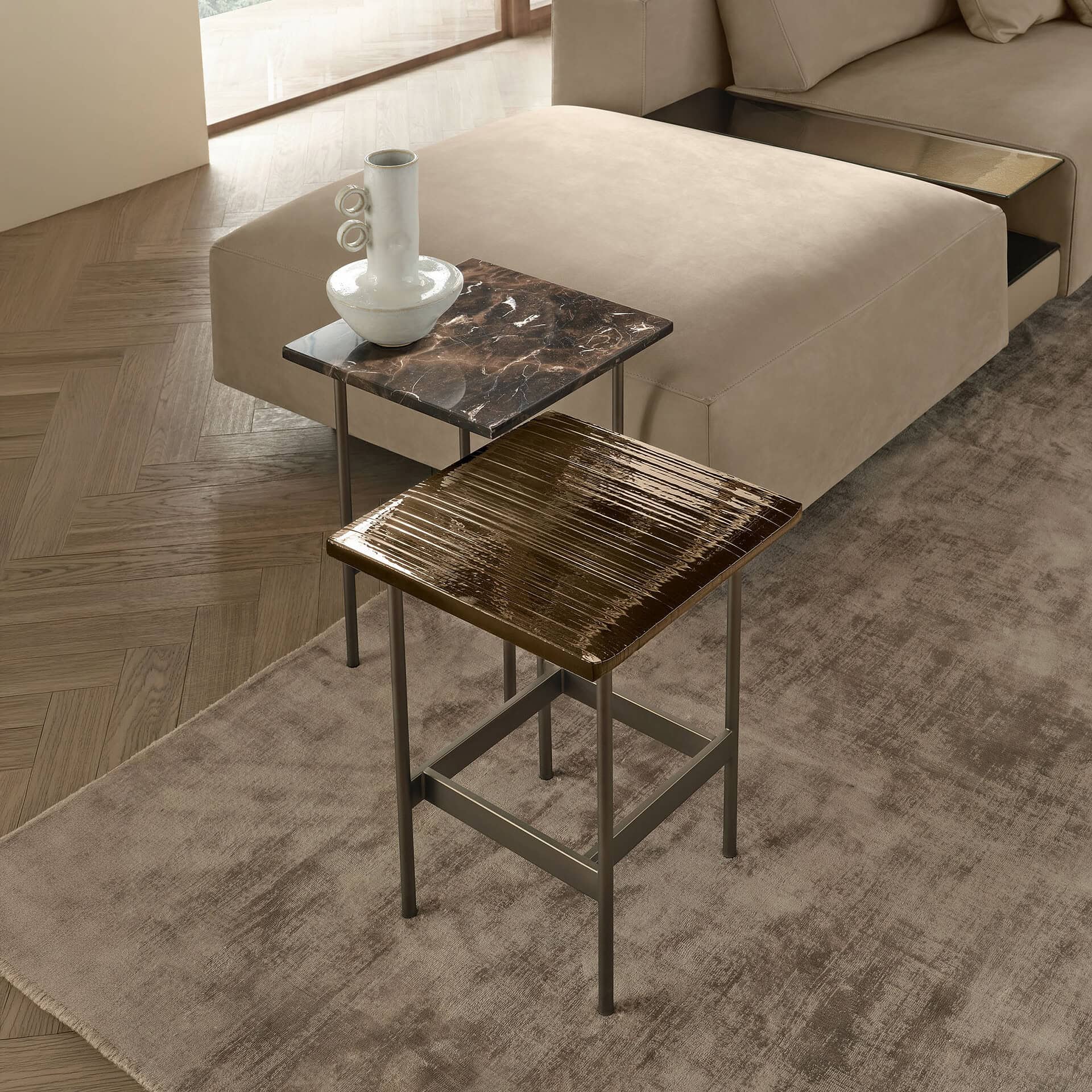 Stylish side tables in a contemporary living room setting with decorative vases.