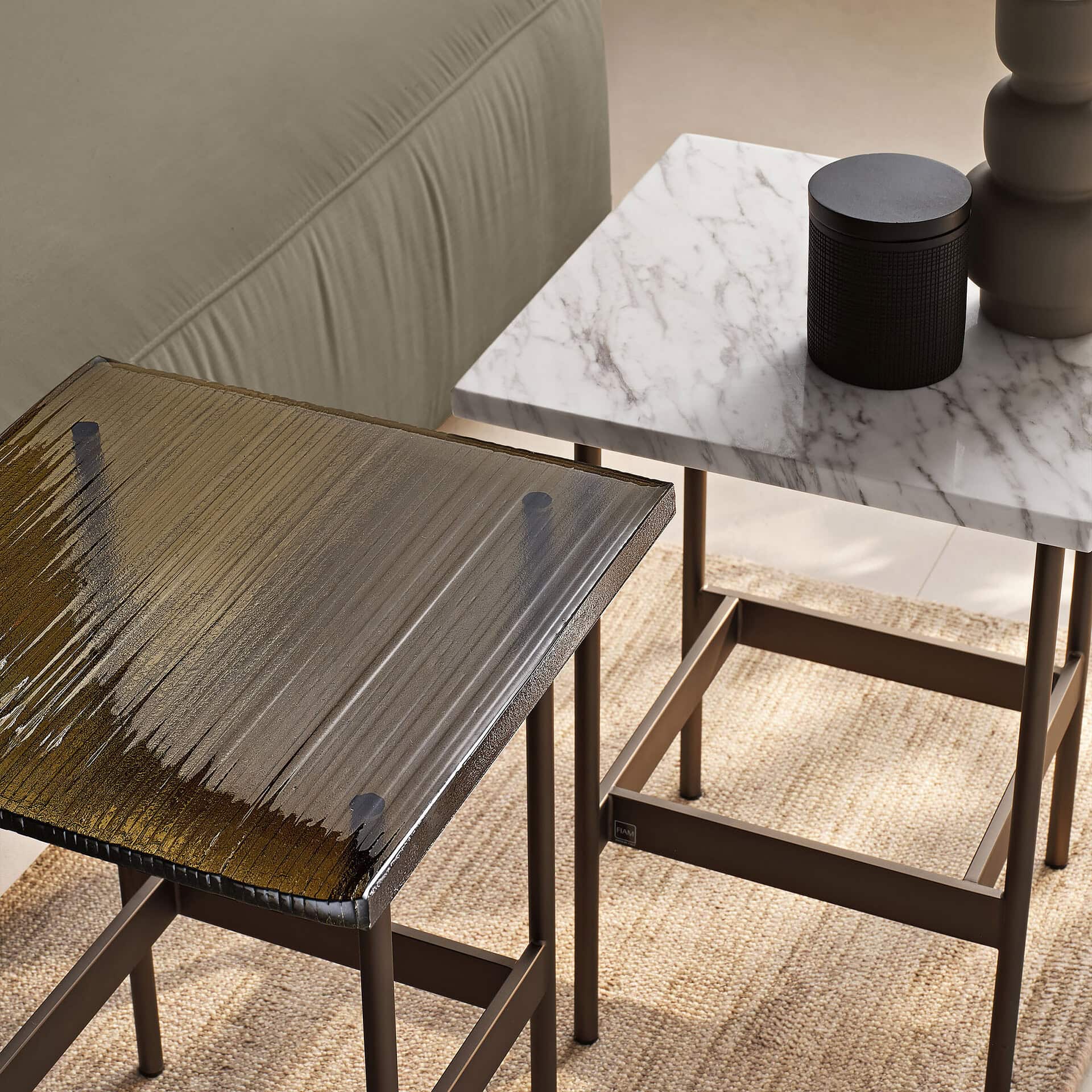 Elegant glass and marble side tables for stylish living room decor.
