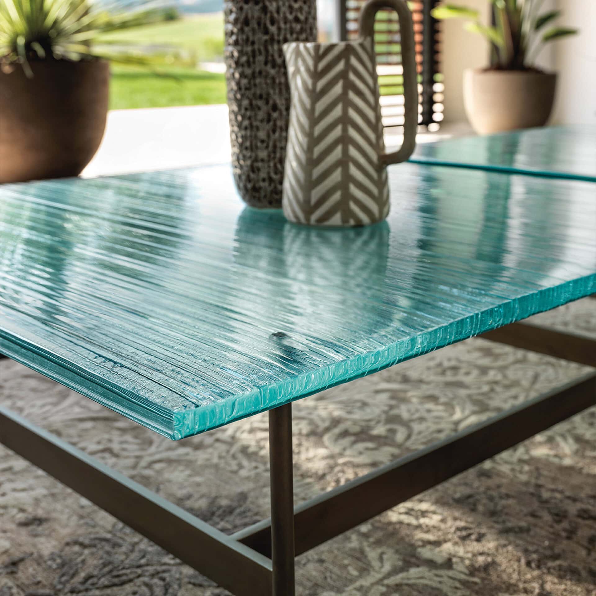 Blue wooden dining table with a textured finish, decorated with ceramic vases and potted plants, ide.