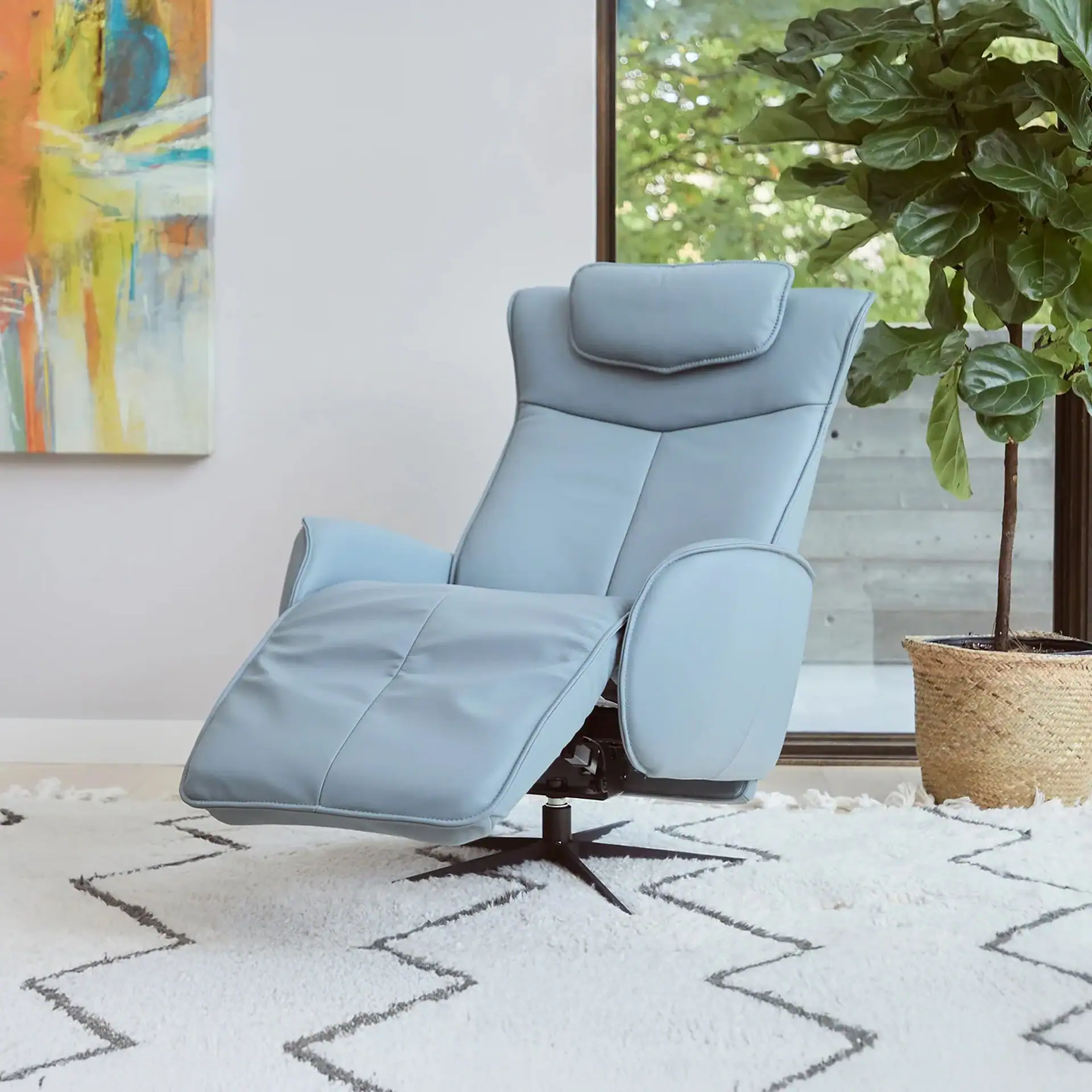 Recliner chair in light blue fabric, perfect for living room relaxation and contemporary decor.