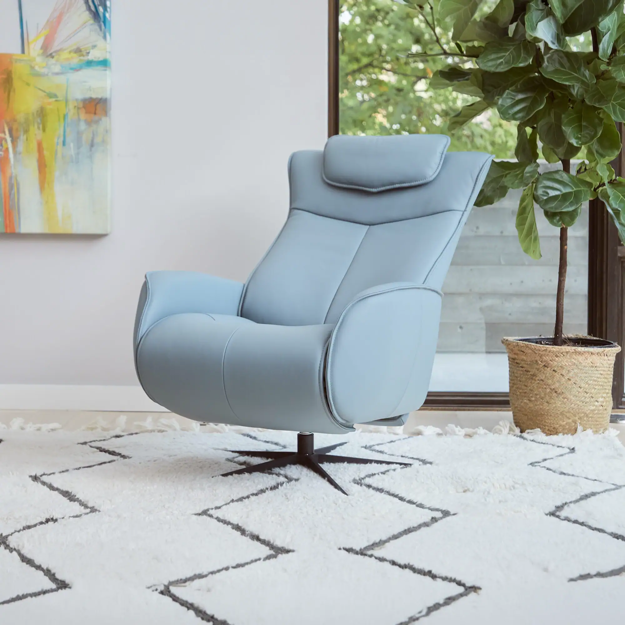 Recliner chair in light blue fabric, perfect for living room relaxation and contemporary decor.