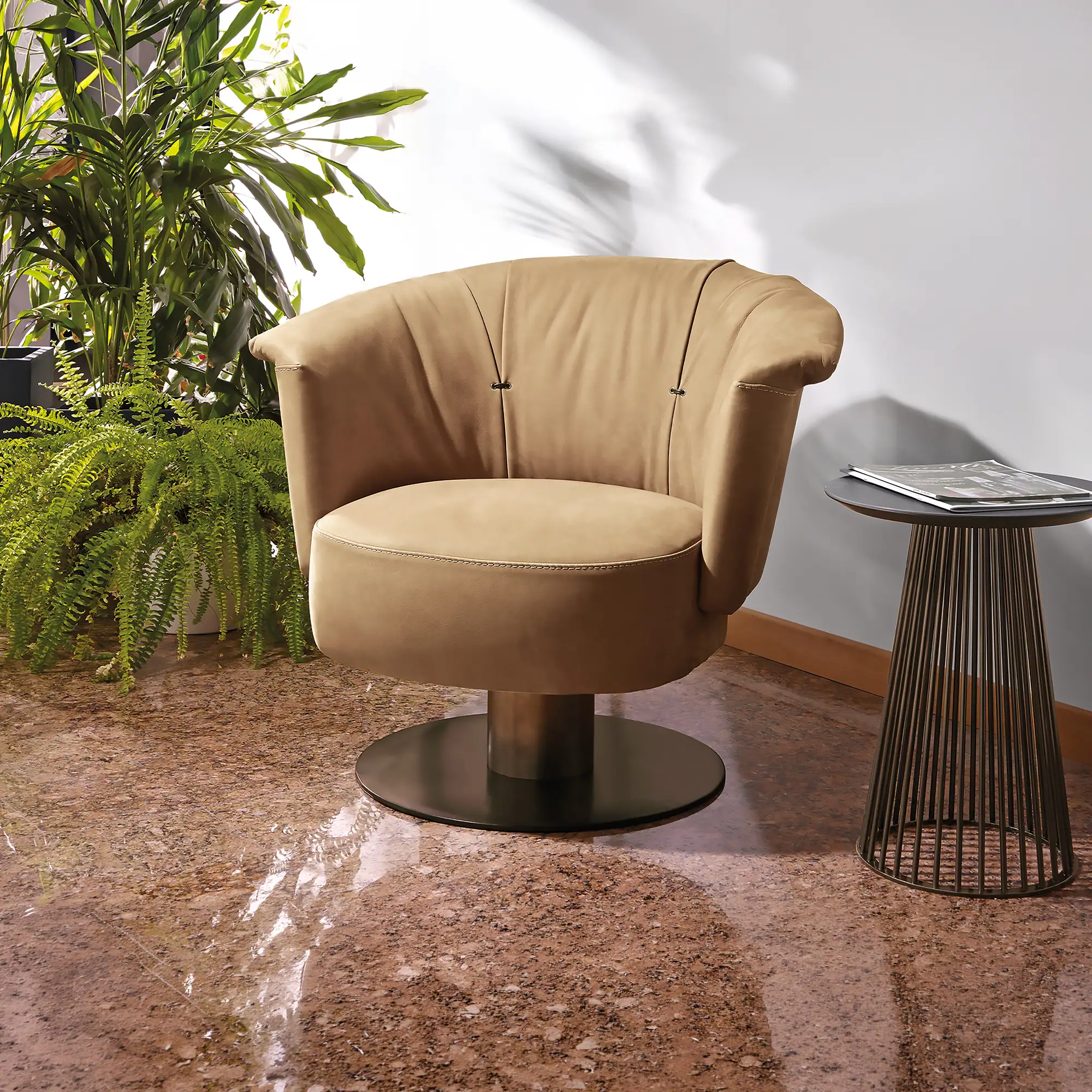 Gamma Luna Armchair in mustard yellow leather with swivel base, styled in a modern living room setting.
