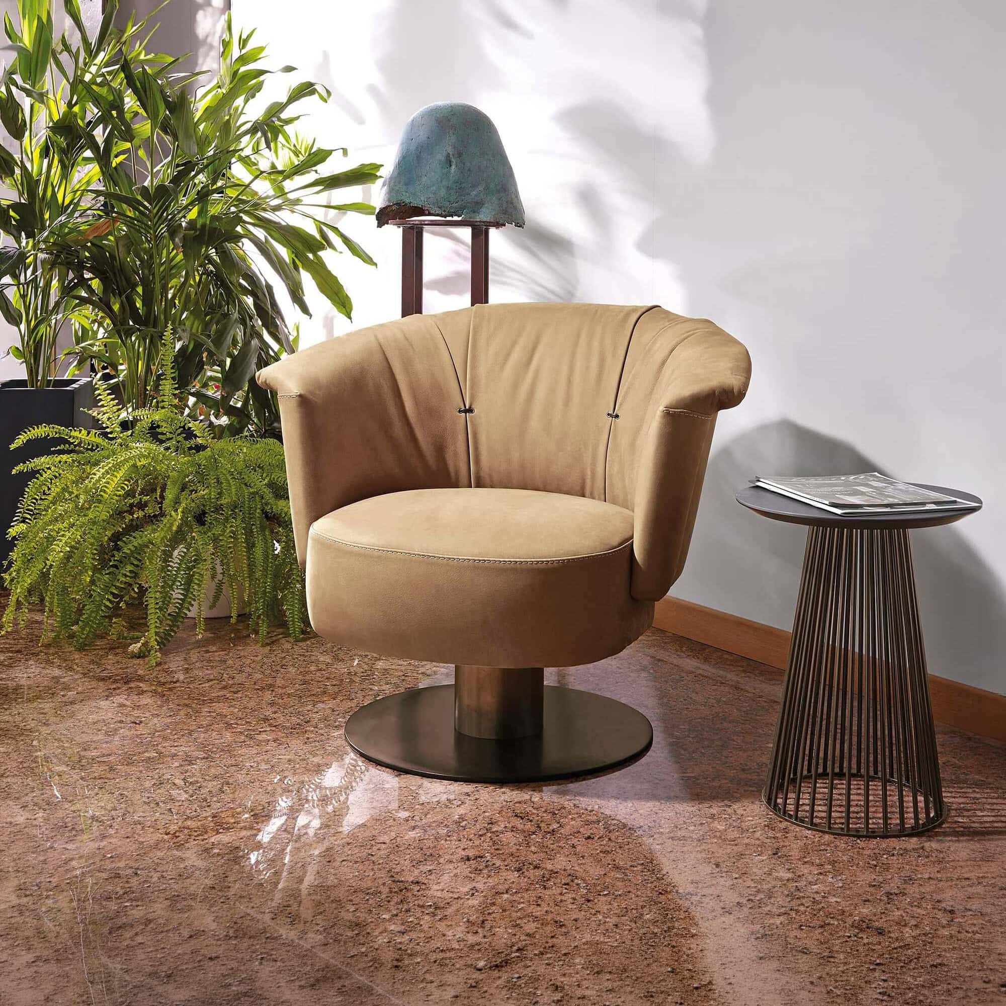 Gamma Luna Armchair in mustard yellow leather with swivel base, styled in a modern living room setting.