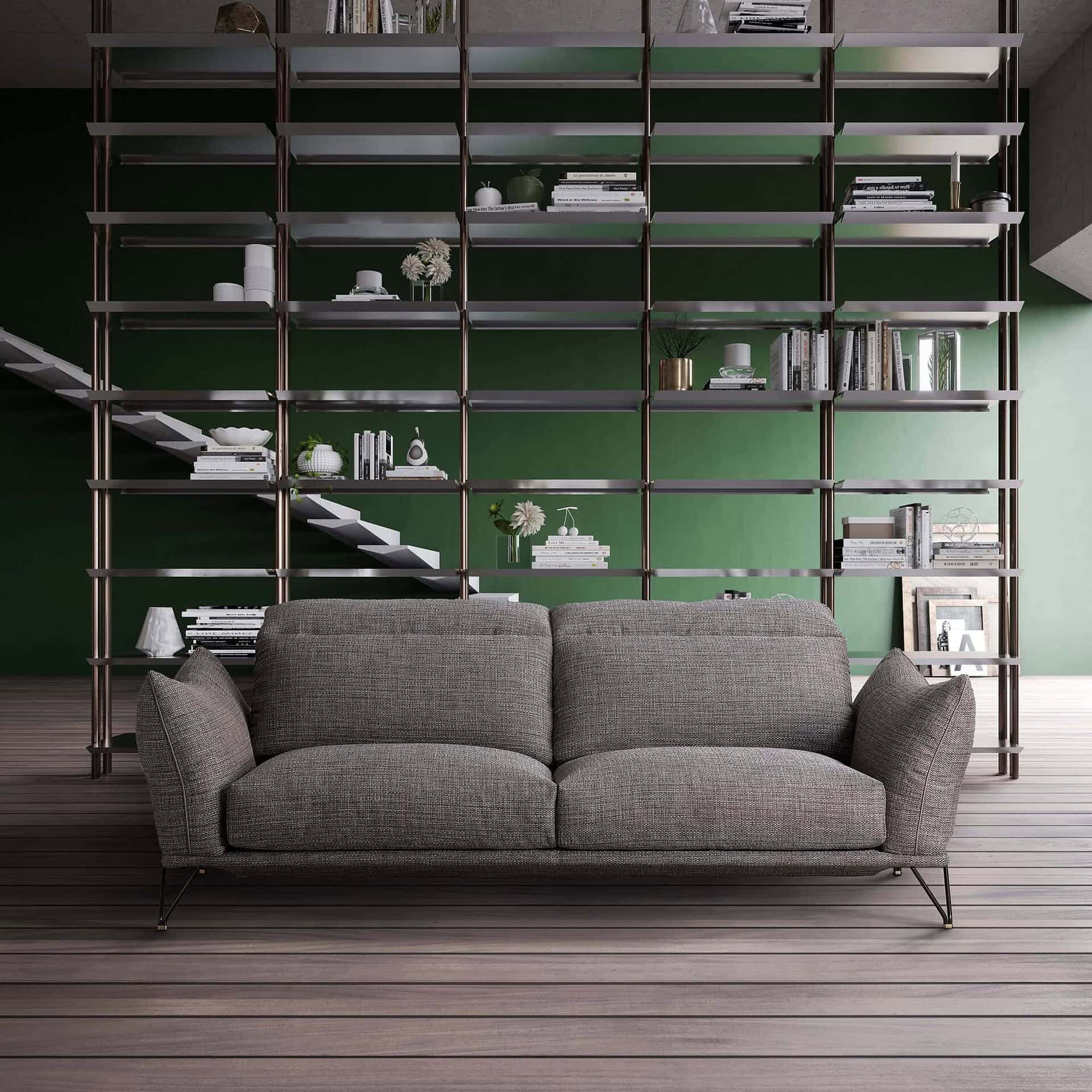 Two-seat Dagor Sofa with slim gunmetal legs, shown against a green wall with open shelving.