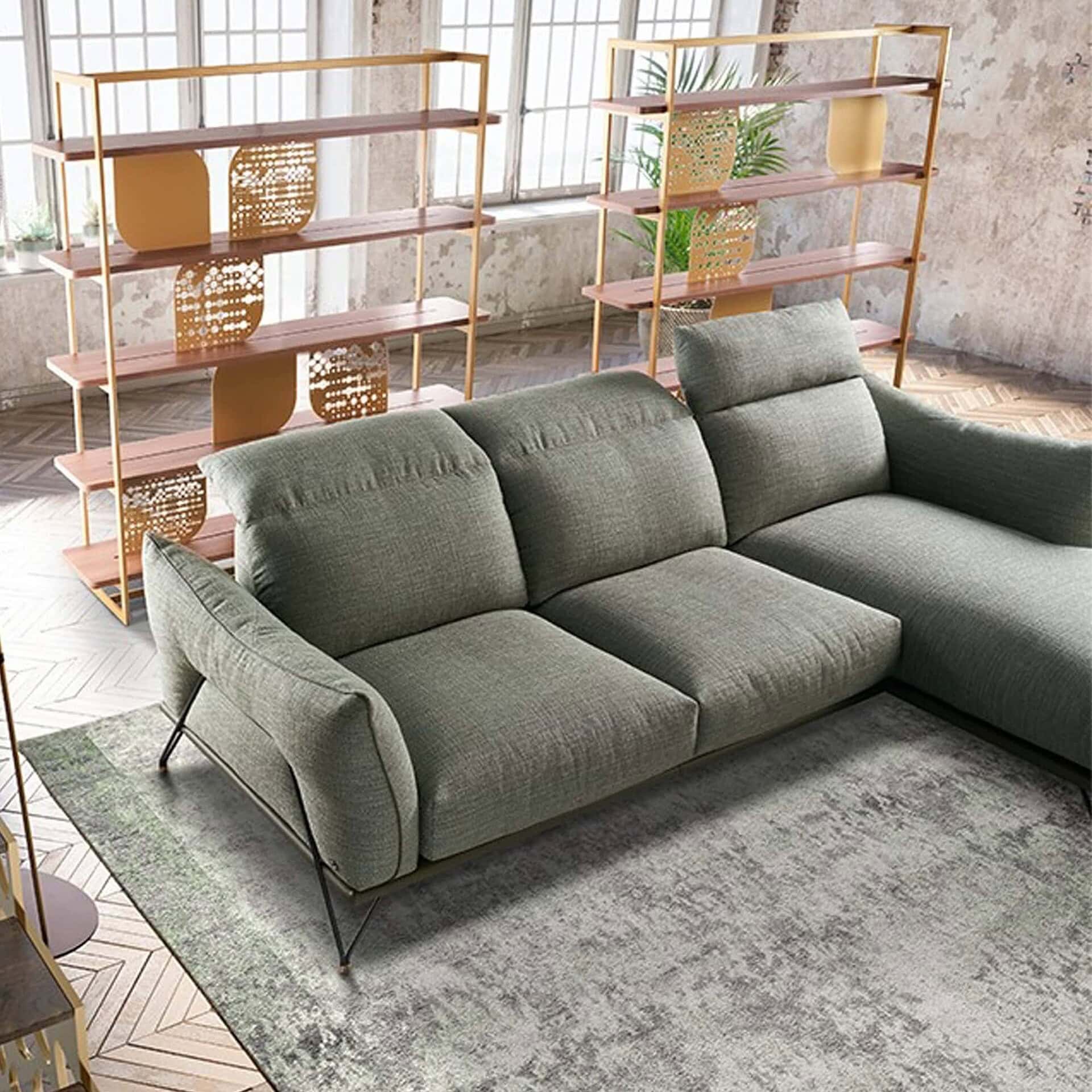 Dagor Sectional Sofa in green upholstery with chaise, shown in a modern loft interior.