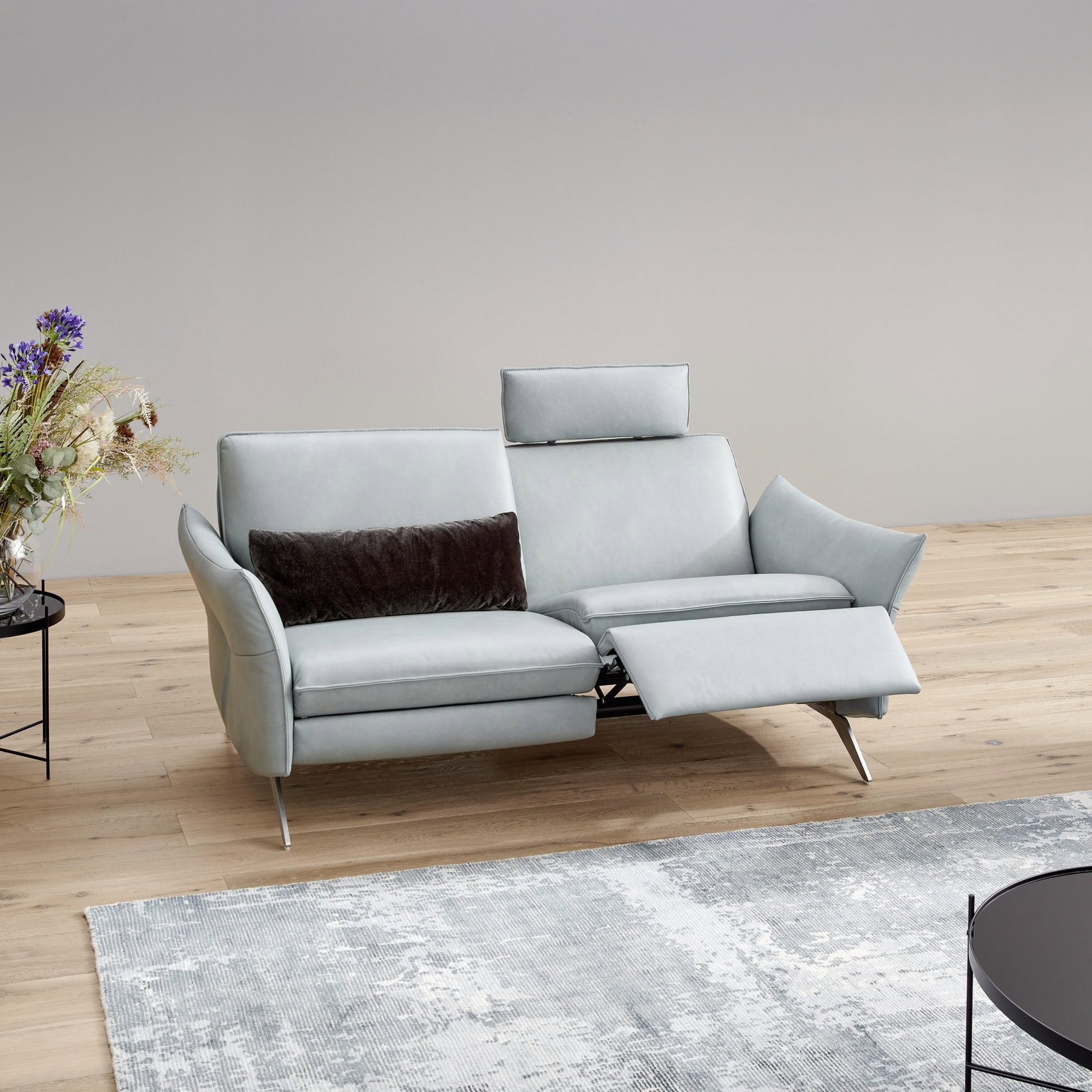Siegfried 6902 Reclining Sofa in light grey fabric, displayed in a modern living room.