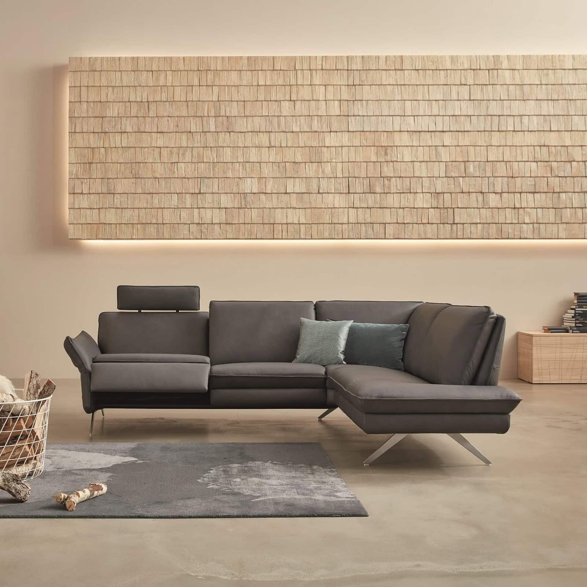 Siegfried 6902 Reclining Sofa in dark grey fabric with extended footrests.