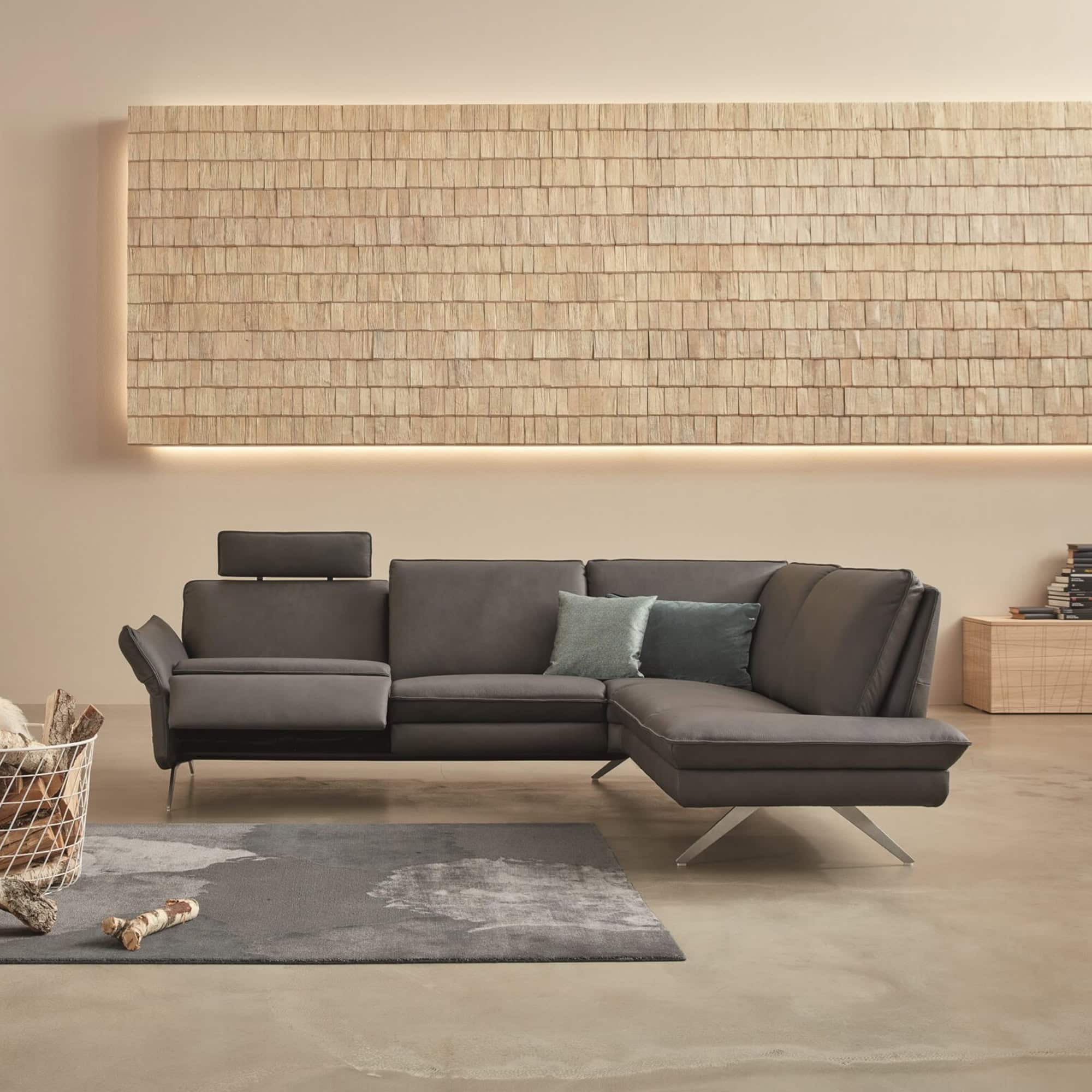 Siegfried 6902 Reclining Sofa in dark grey fabric with extended footrests.