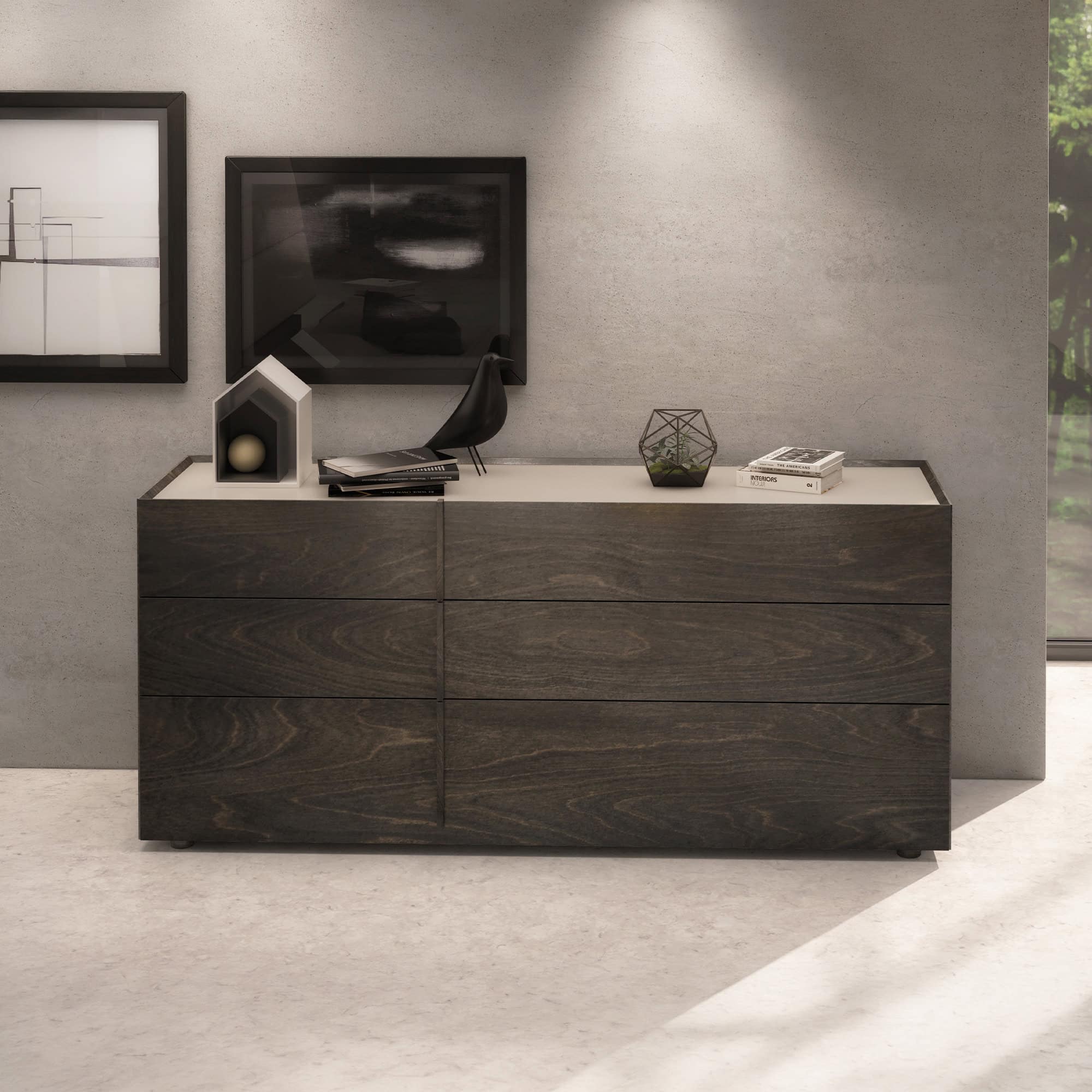 Huppé Plank dresser with six drawers in a dark walnut finish, styled in a modern interior with decorative objects on top.