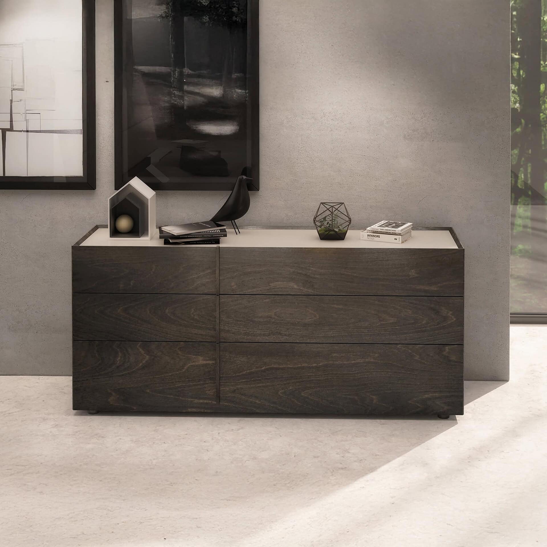 Huppé Plank dresser with six drawers in a dark walnut finish, styled in a modern interior with decorative objects on top.